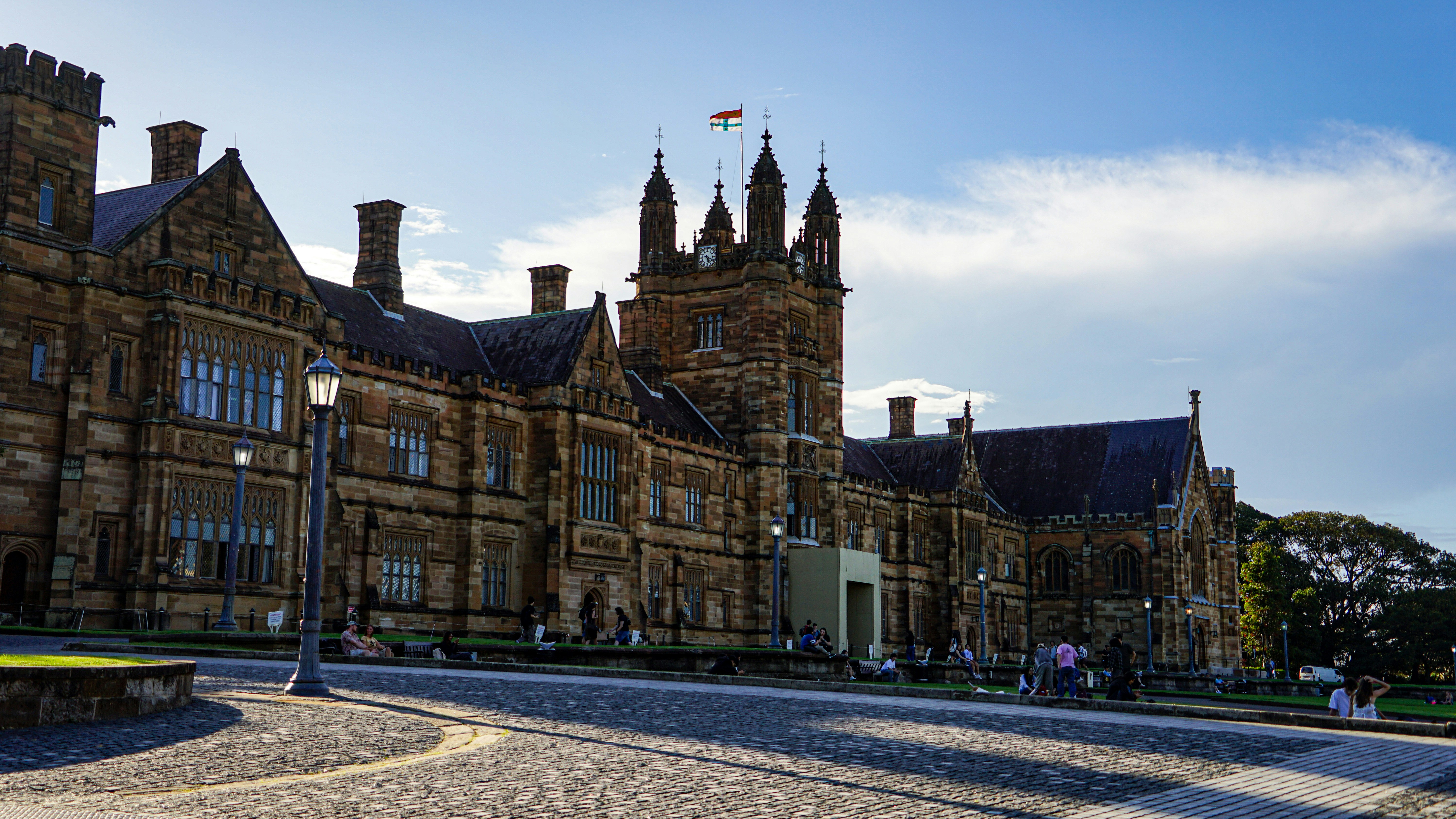 Historic stone university building with a clock tower.