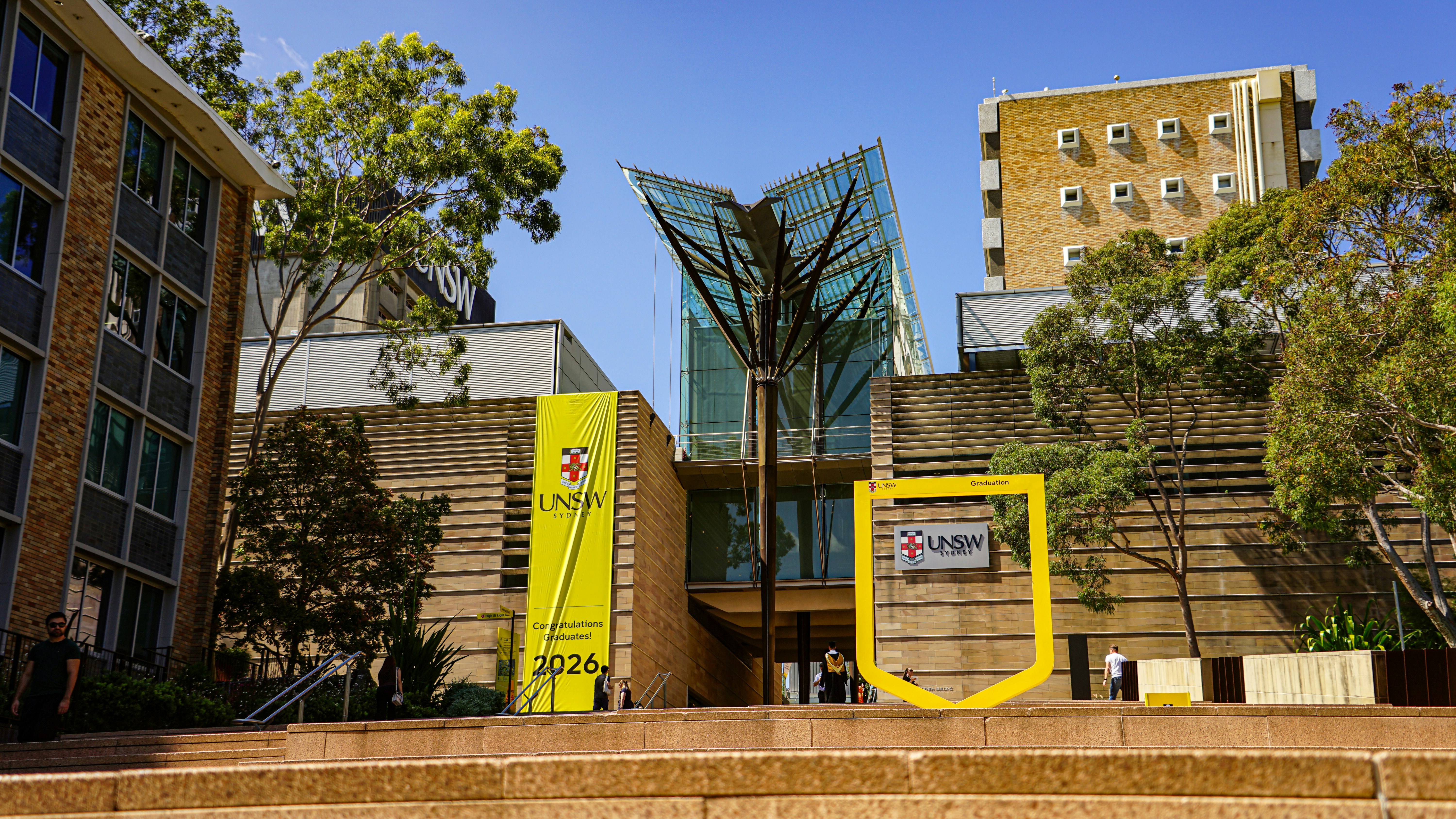 Modern university building with glass entrance and signage