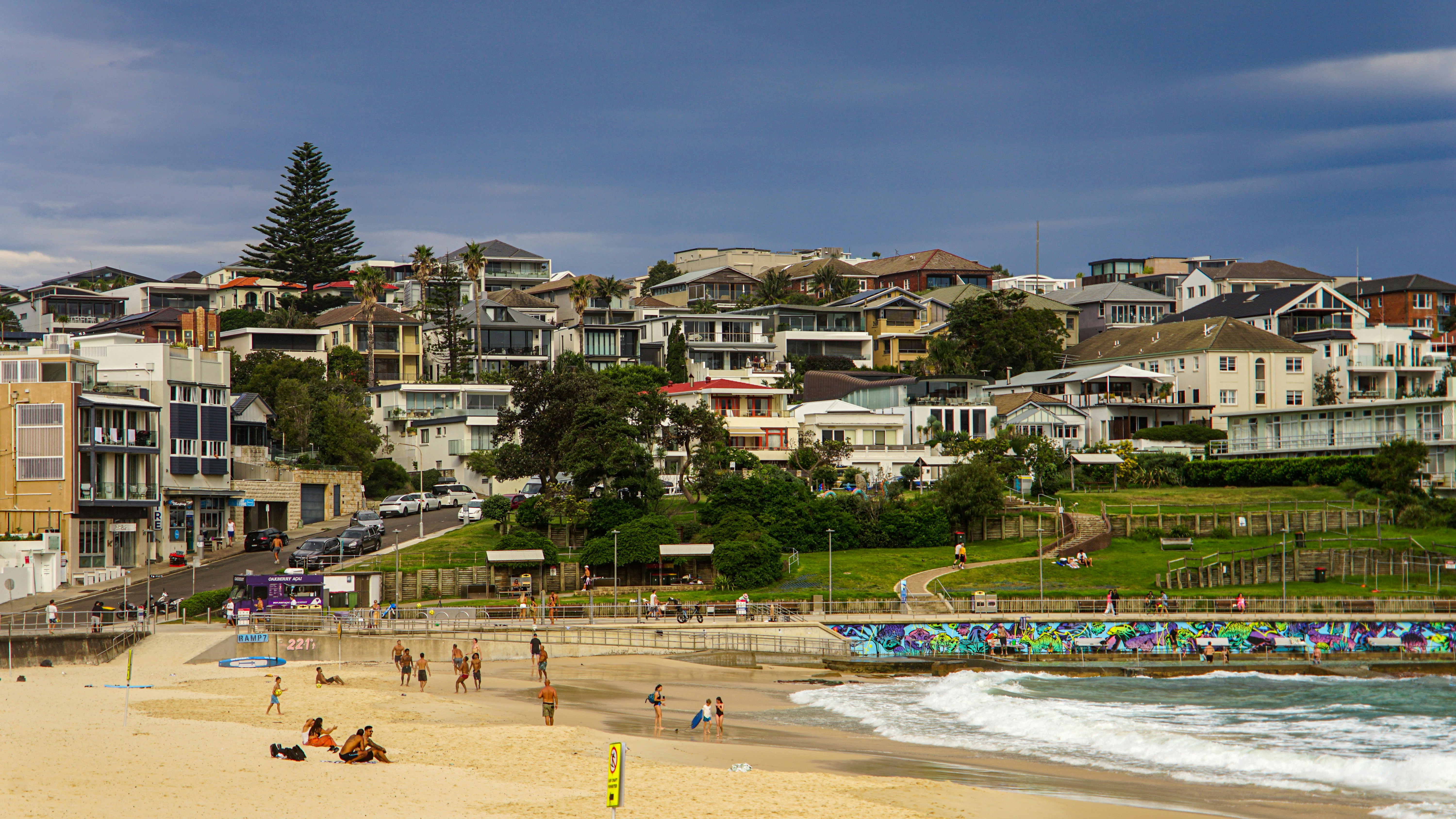 Beachfront homes overlooking a sandy beach and ocean waves