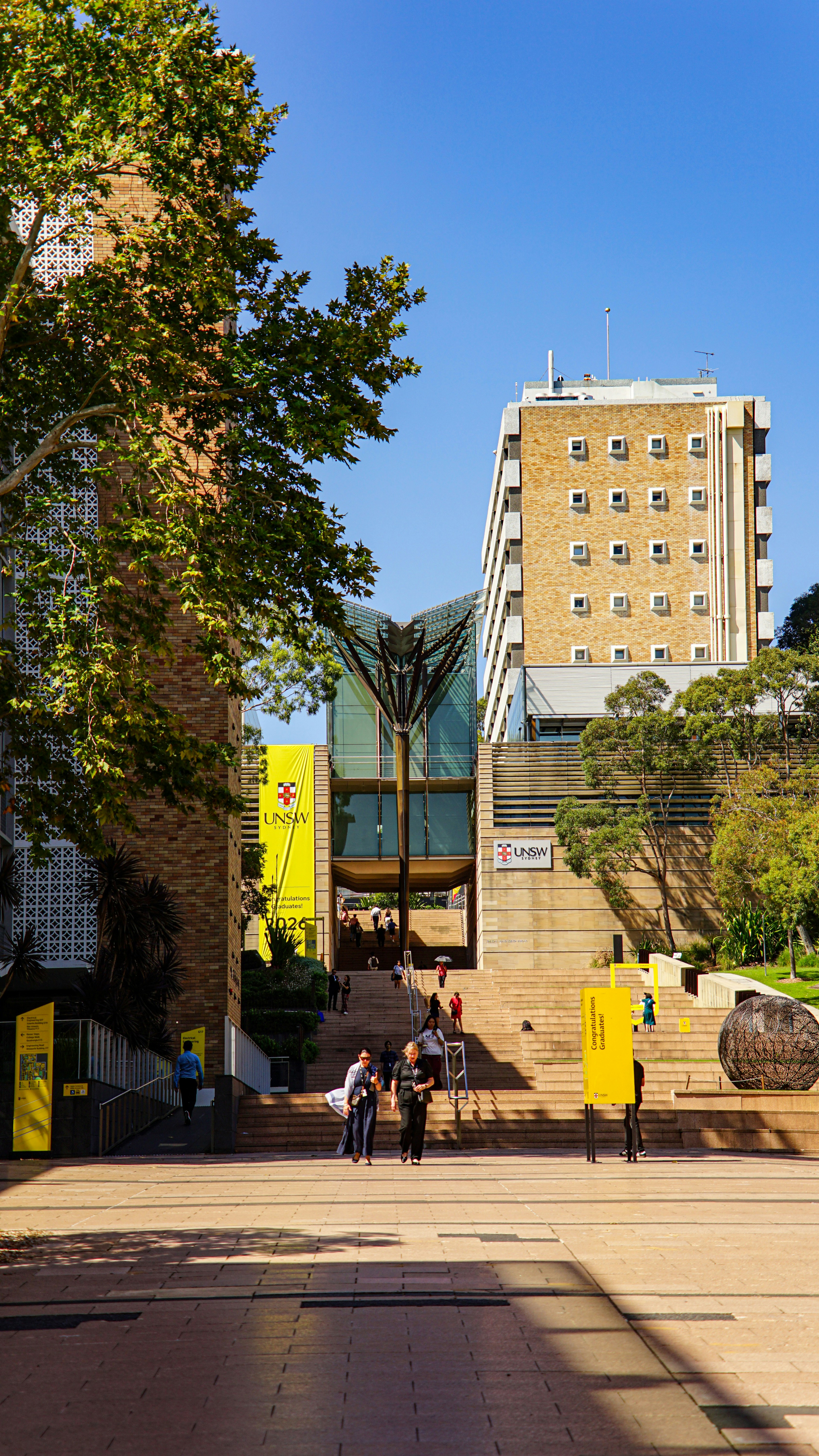 Students walking up the steps of a campus building