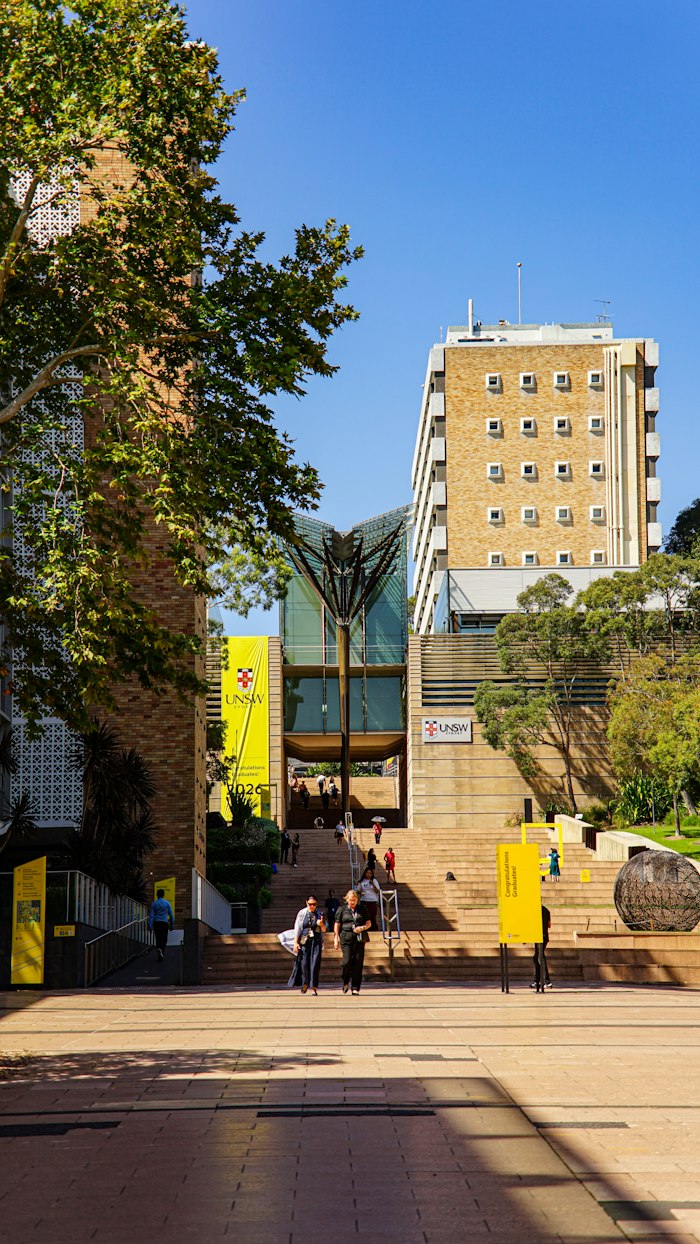 Students walking up the steps of a university campus