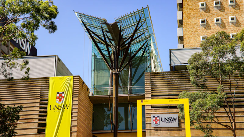 Modern glass building with yellow UNSW signage, Sydney