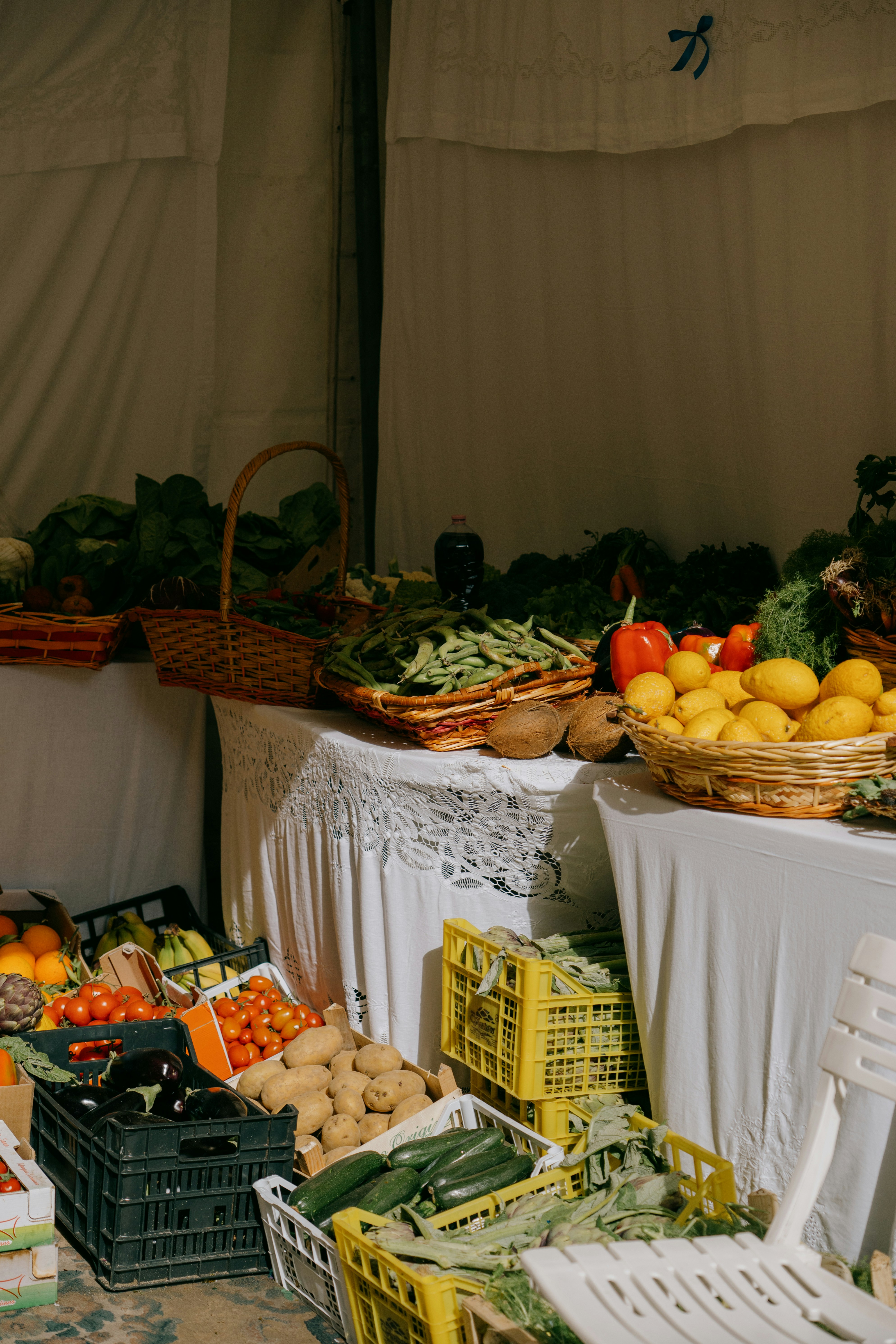 Fresh produce displayed in crates and baskets at a market.
