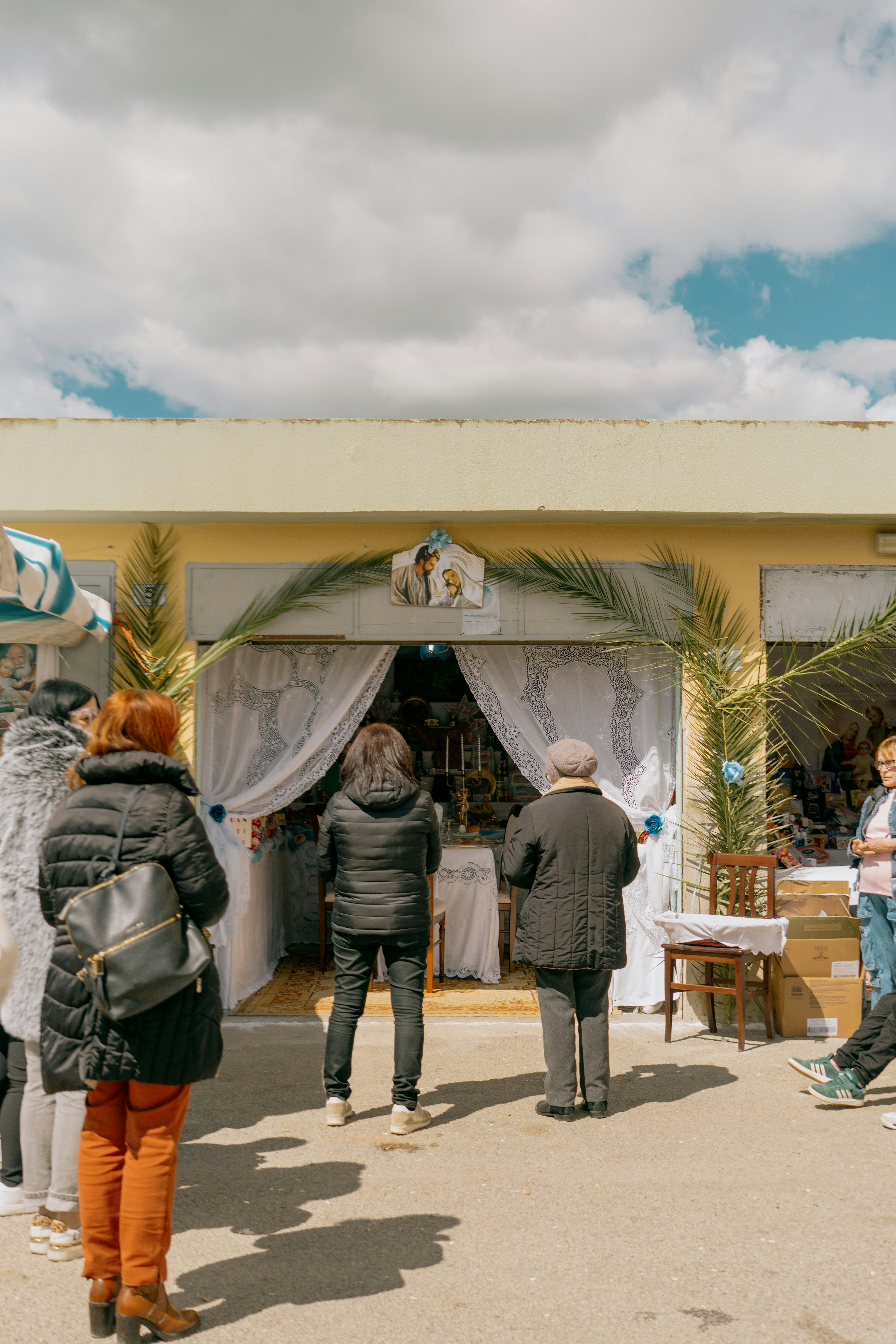 People gathered outside a decorated storefront