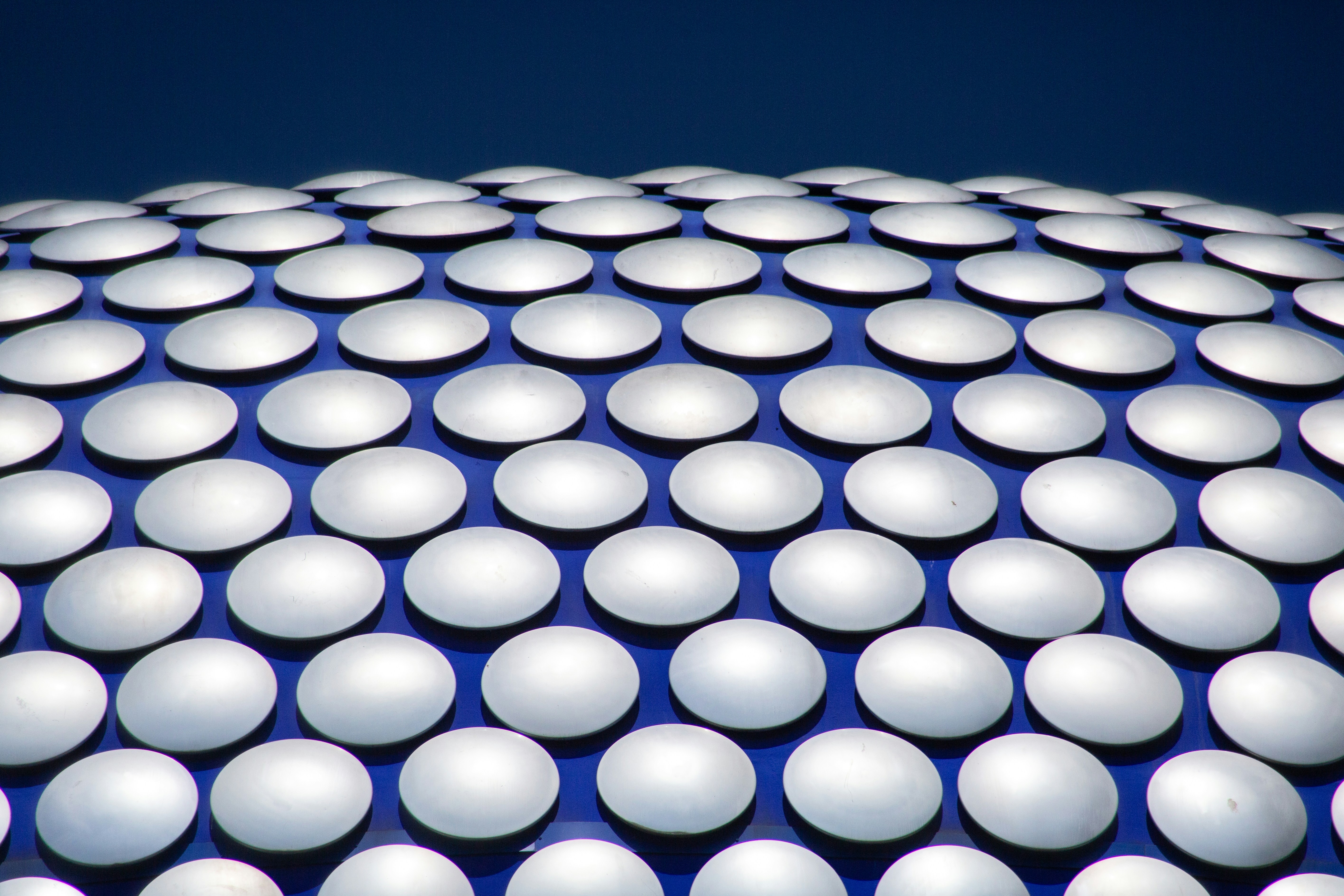 Silver discs on a blue background