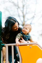 Mother and child on a playground slide