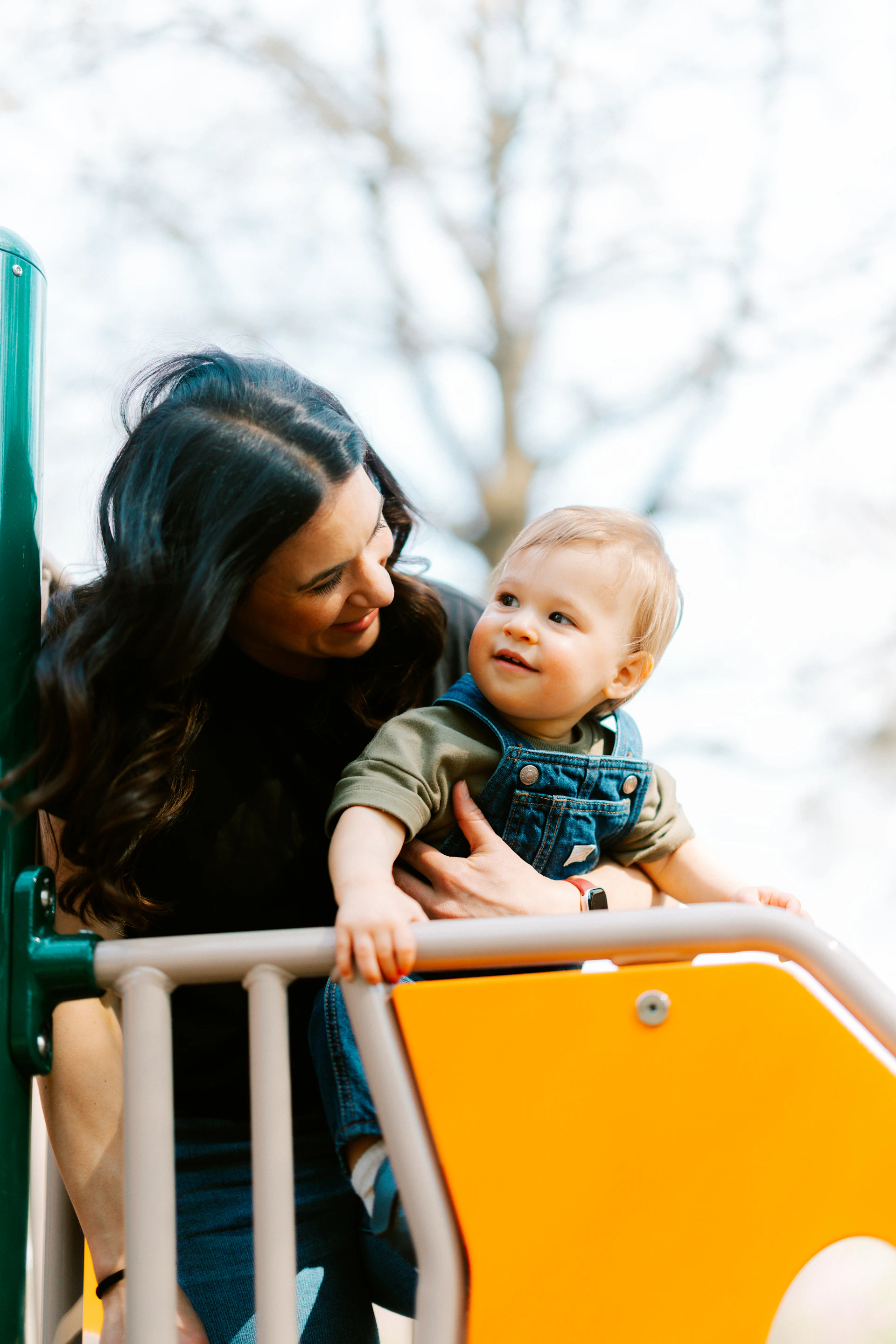 Mother and child on a playground slide