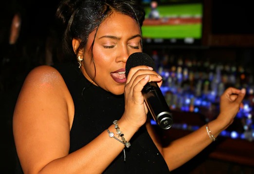 A woman singing passionately into a microphone