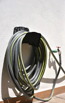 Garden hose coiled on a wall mount