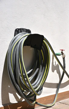 Garden hose coiled on a wall mount