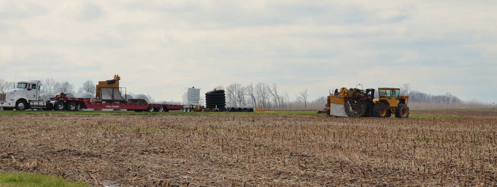 Tractor and truck in a harvested agricultural field