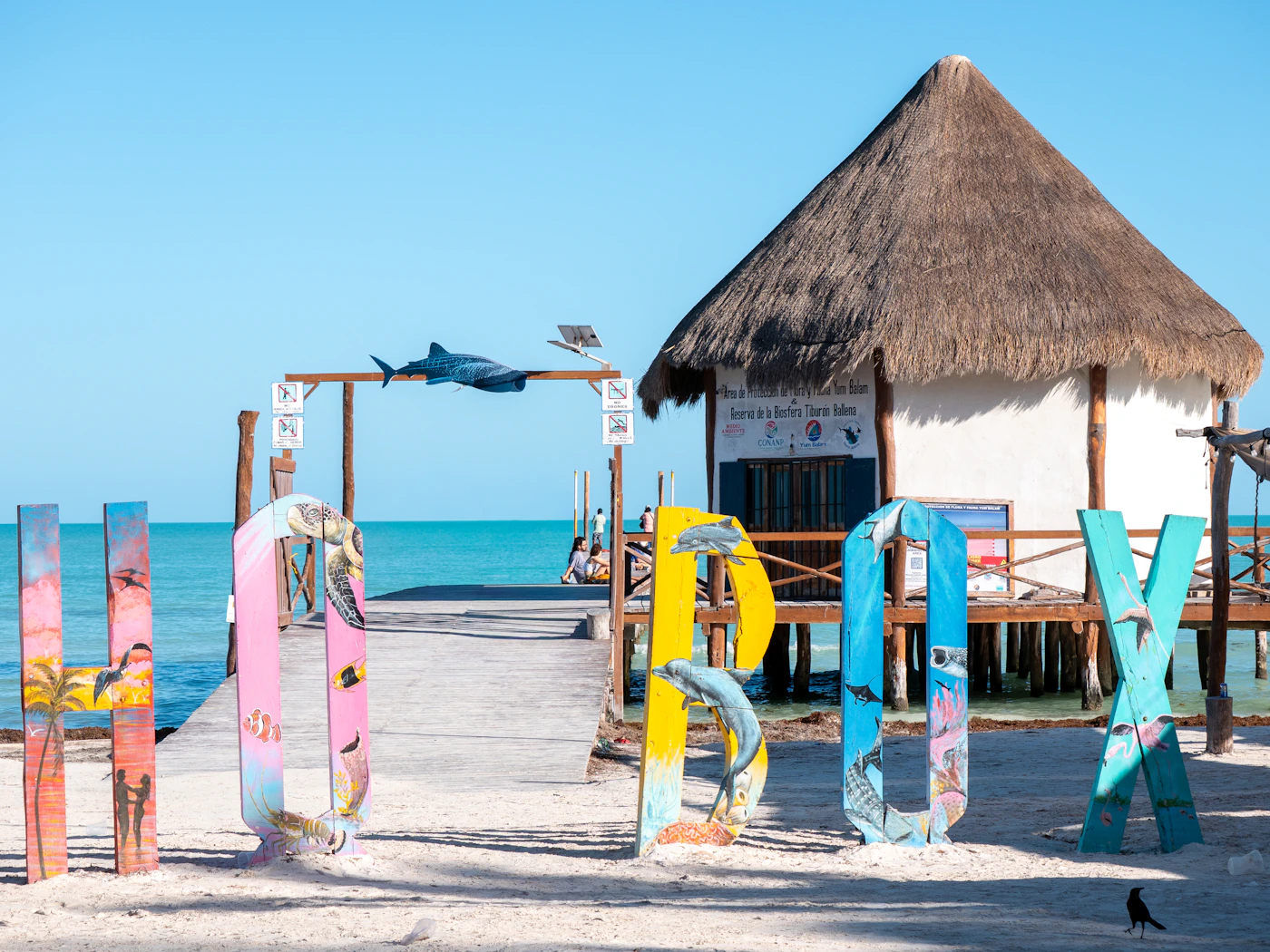 Colourful letters spelling holbox by a beach hut on Isla Holbox Quintana Roo Mexico showing the characteristic island sign and beach setting