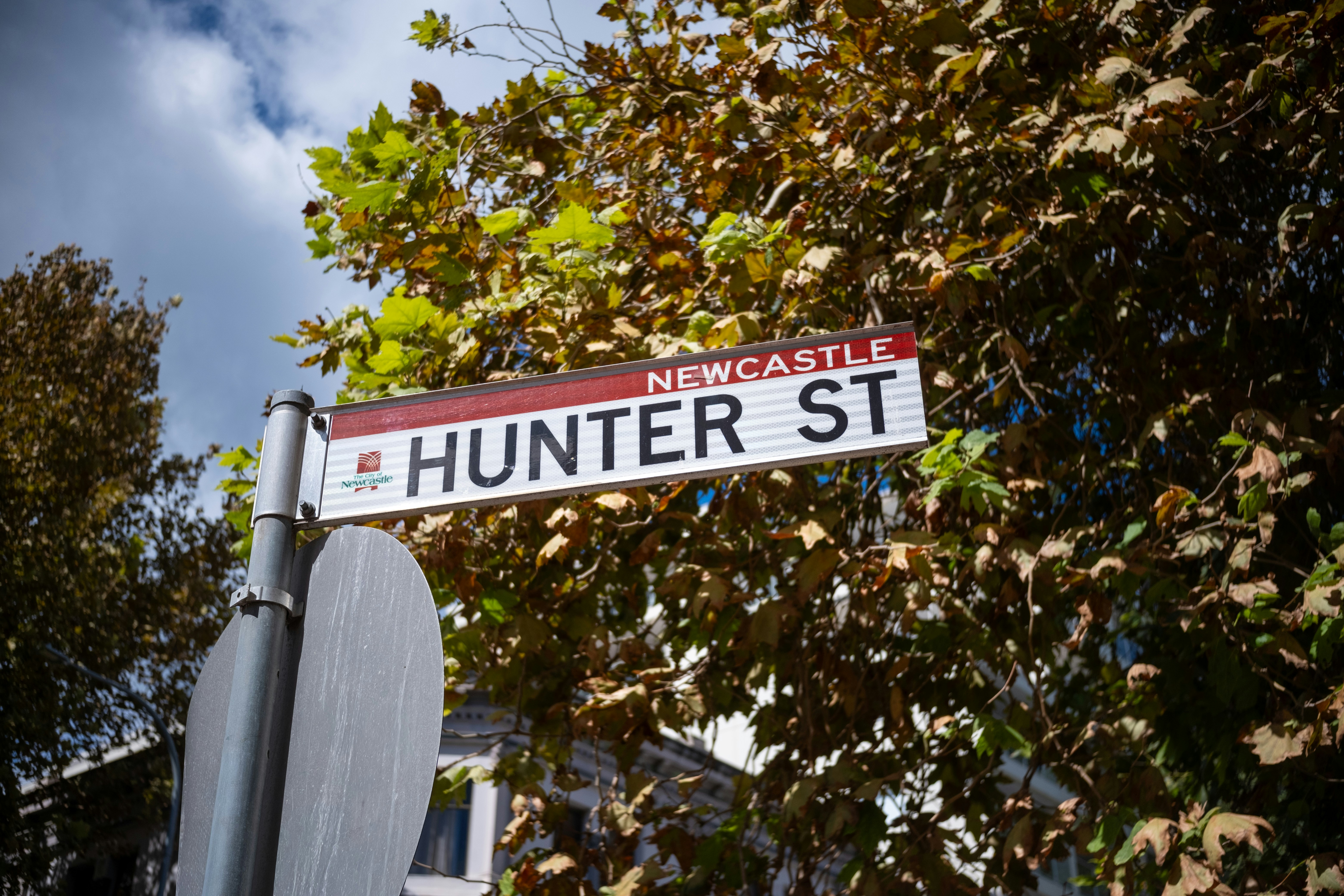 Newcastle hunter street sign with autumn leaves