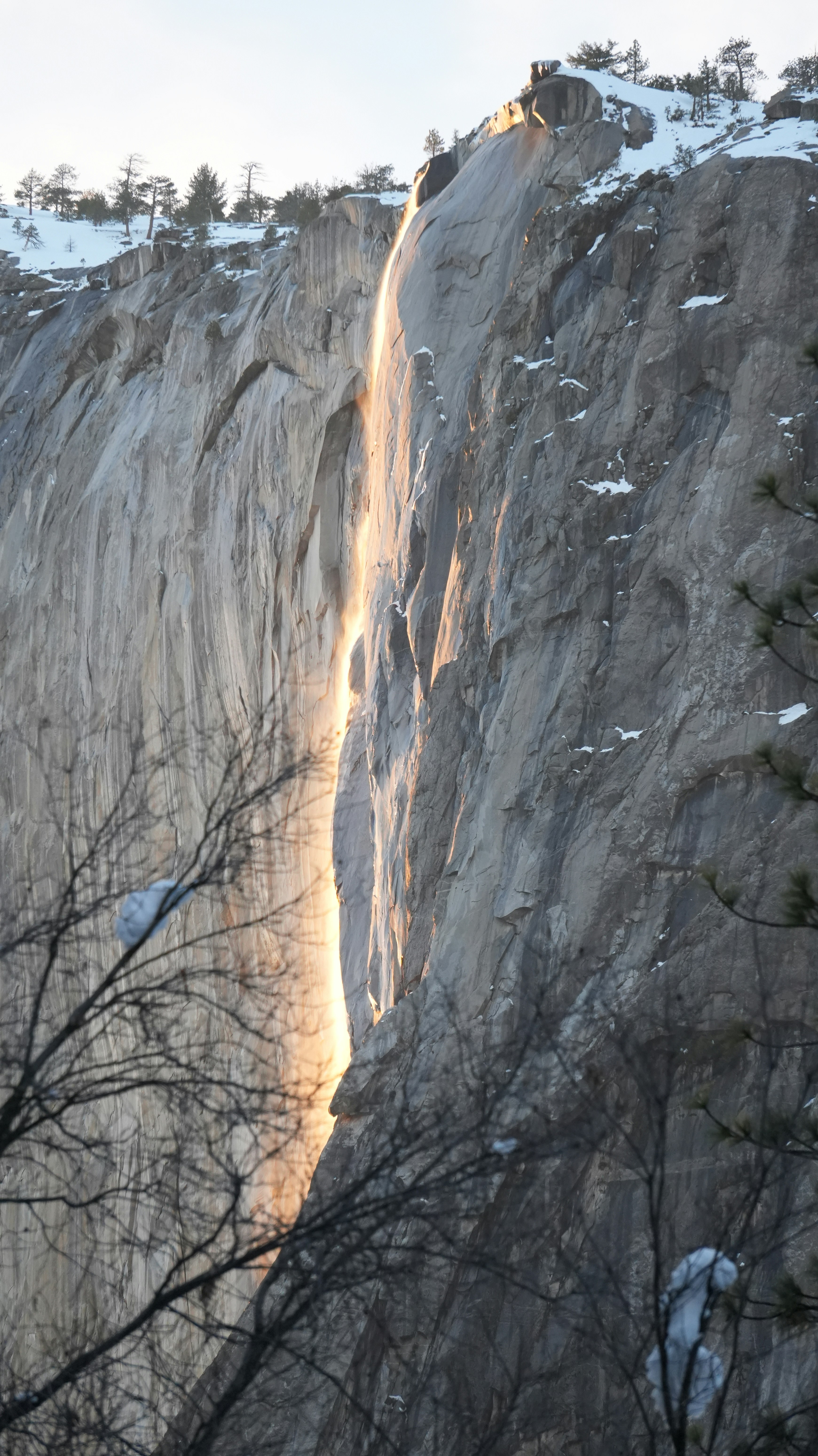 Waterfall cascading down a sheer granite cliff face