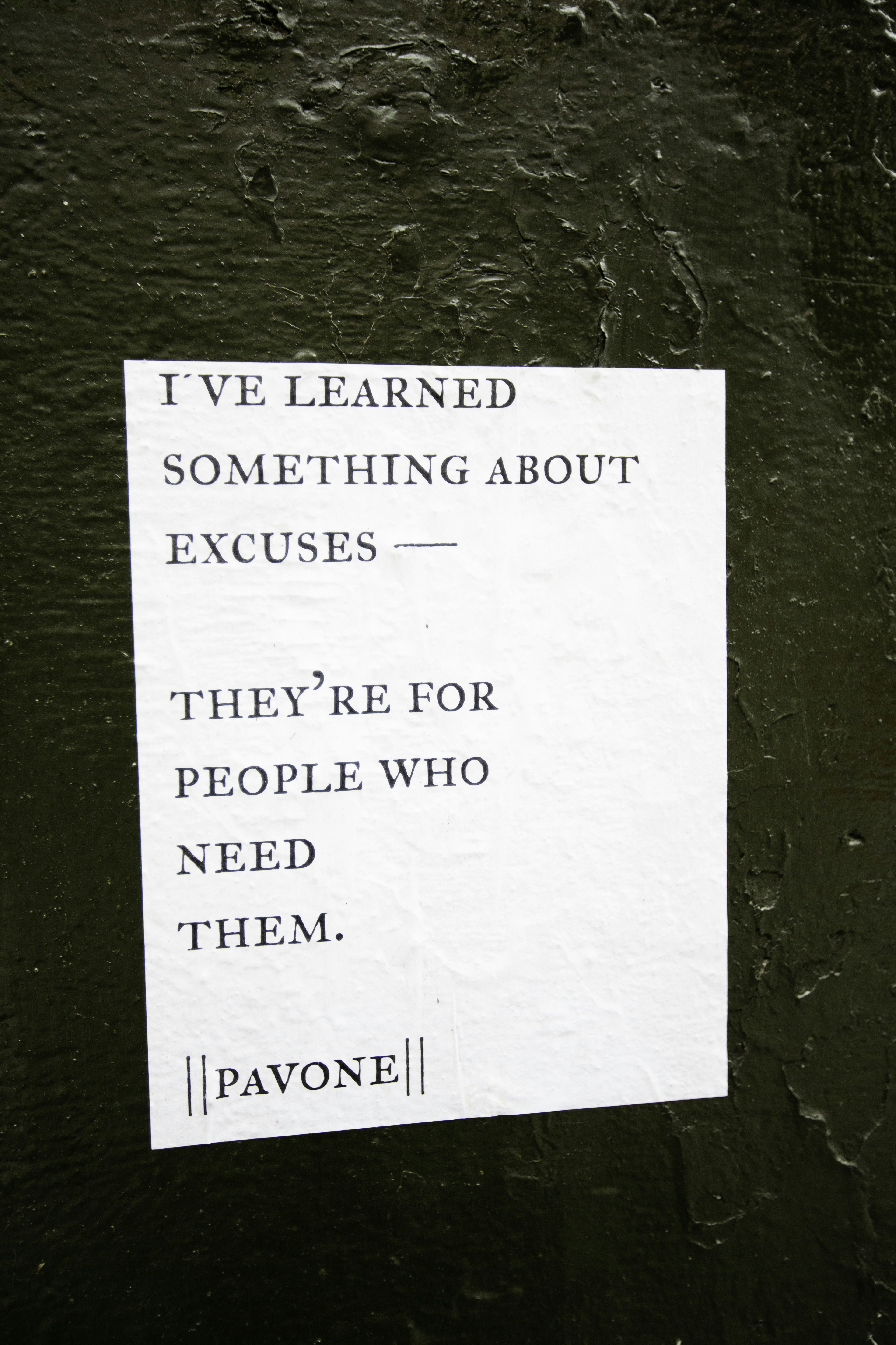 A paper with text about excuses on a textured surface