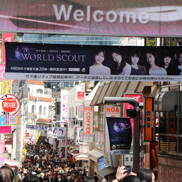Crowded Takeshita Street in Tokyo with shops and banners overhead