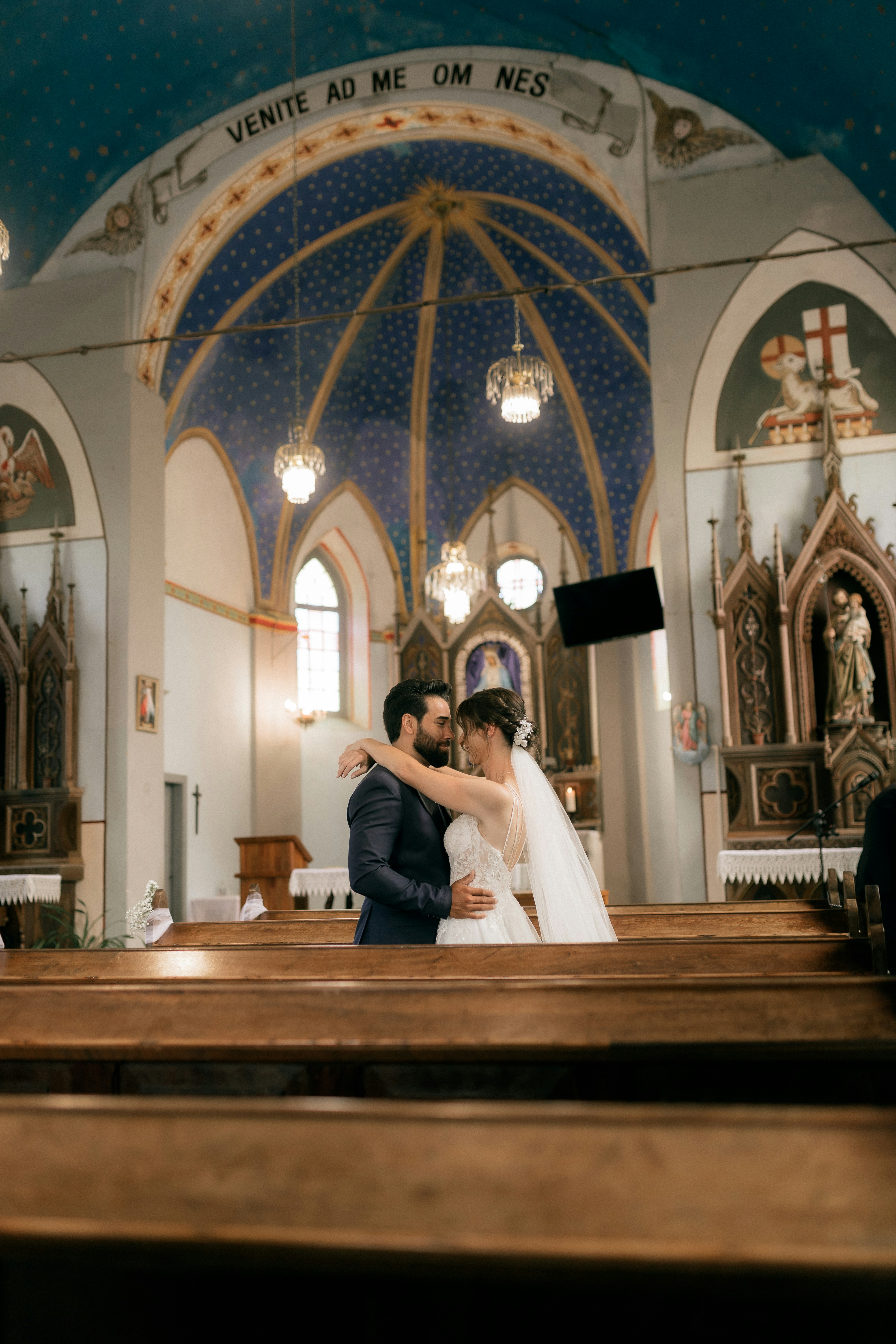 A bride and groom embrace in a church. photo – Free Love Image on Unsplash