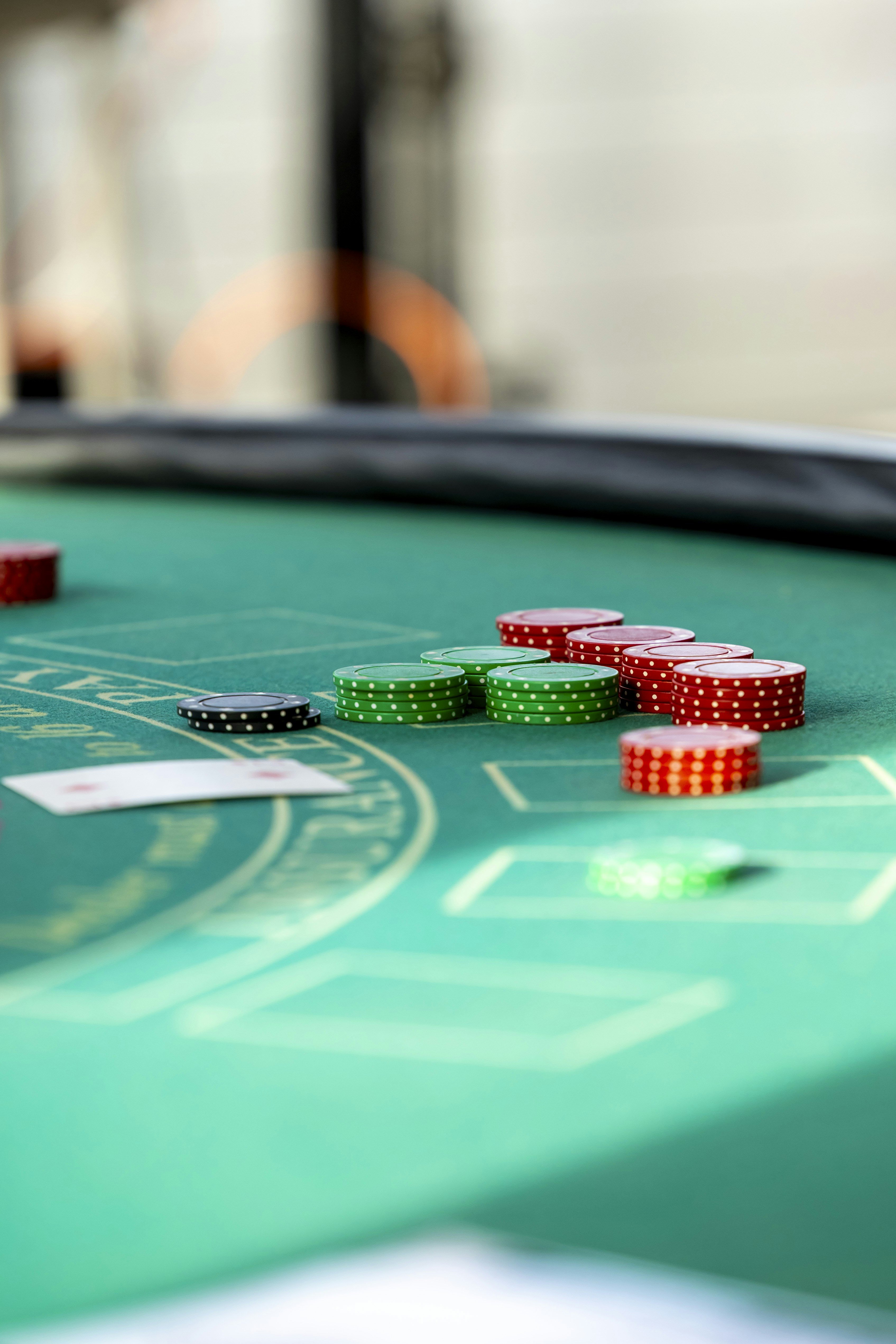 Red and green poker chips on a green felt table