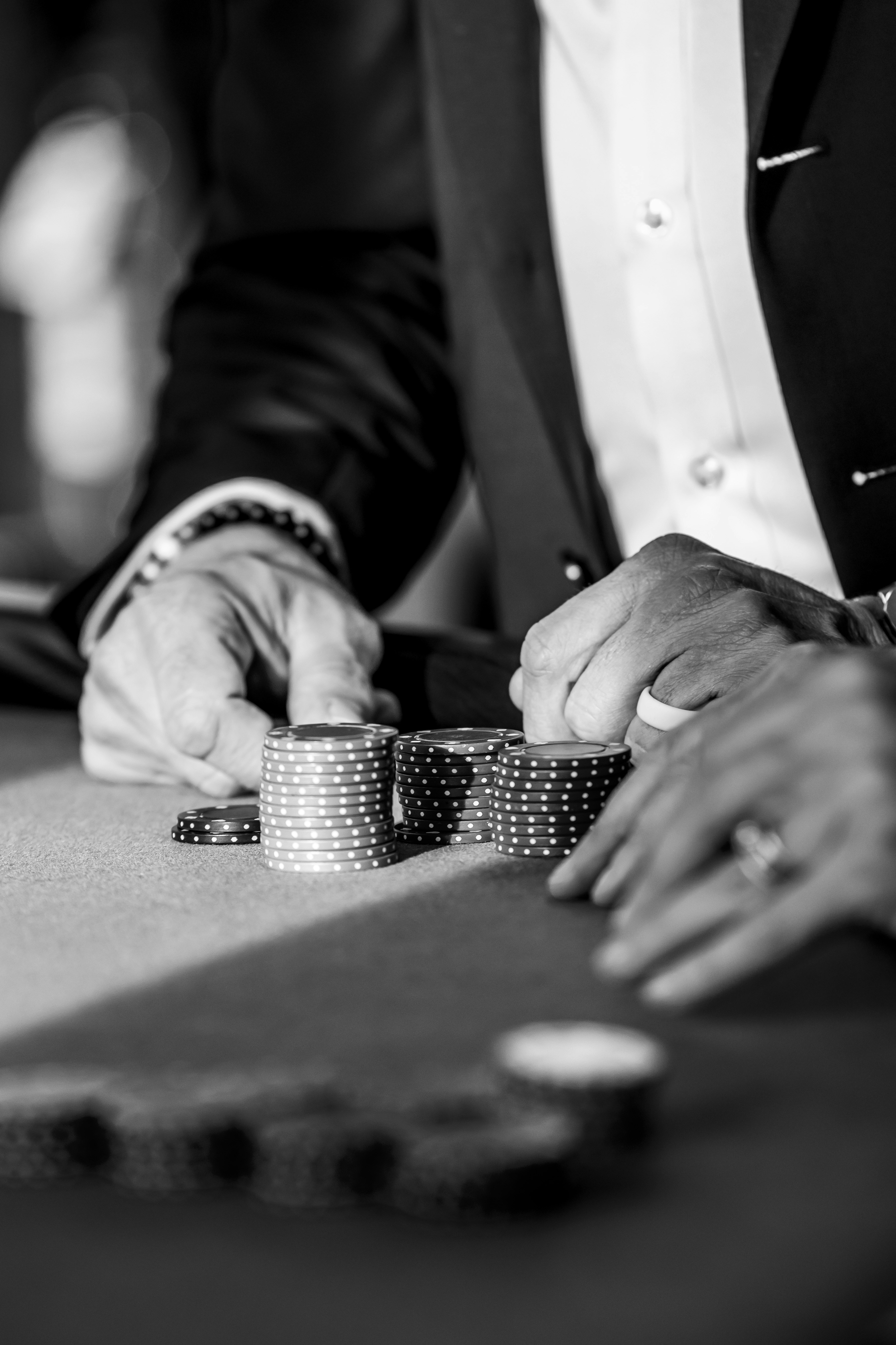 Hands arranging poker chips on a table