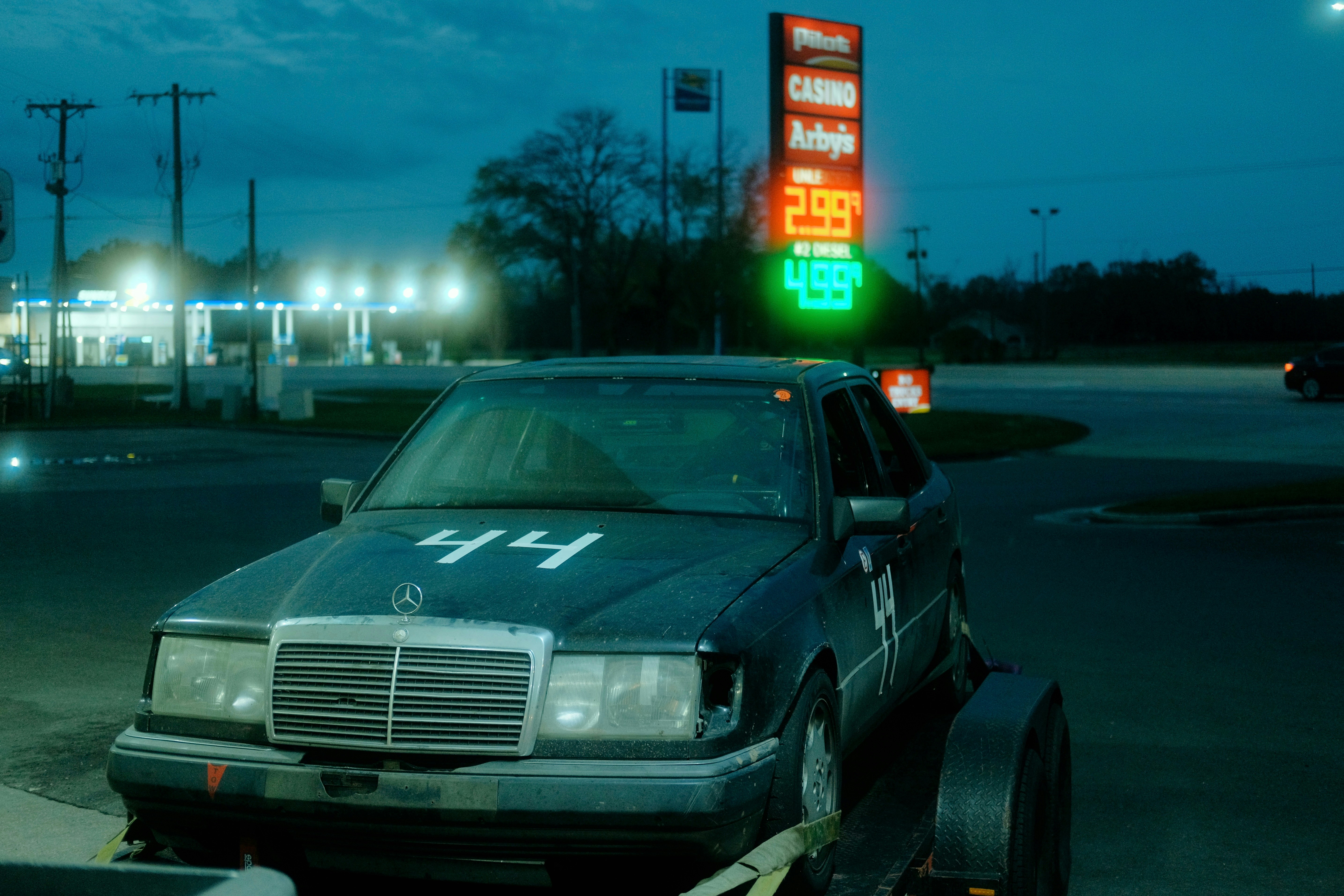 A race car with number 44 on hood at night.