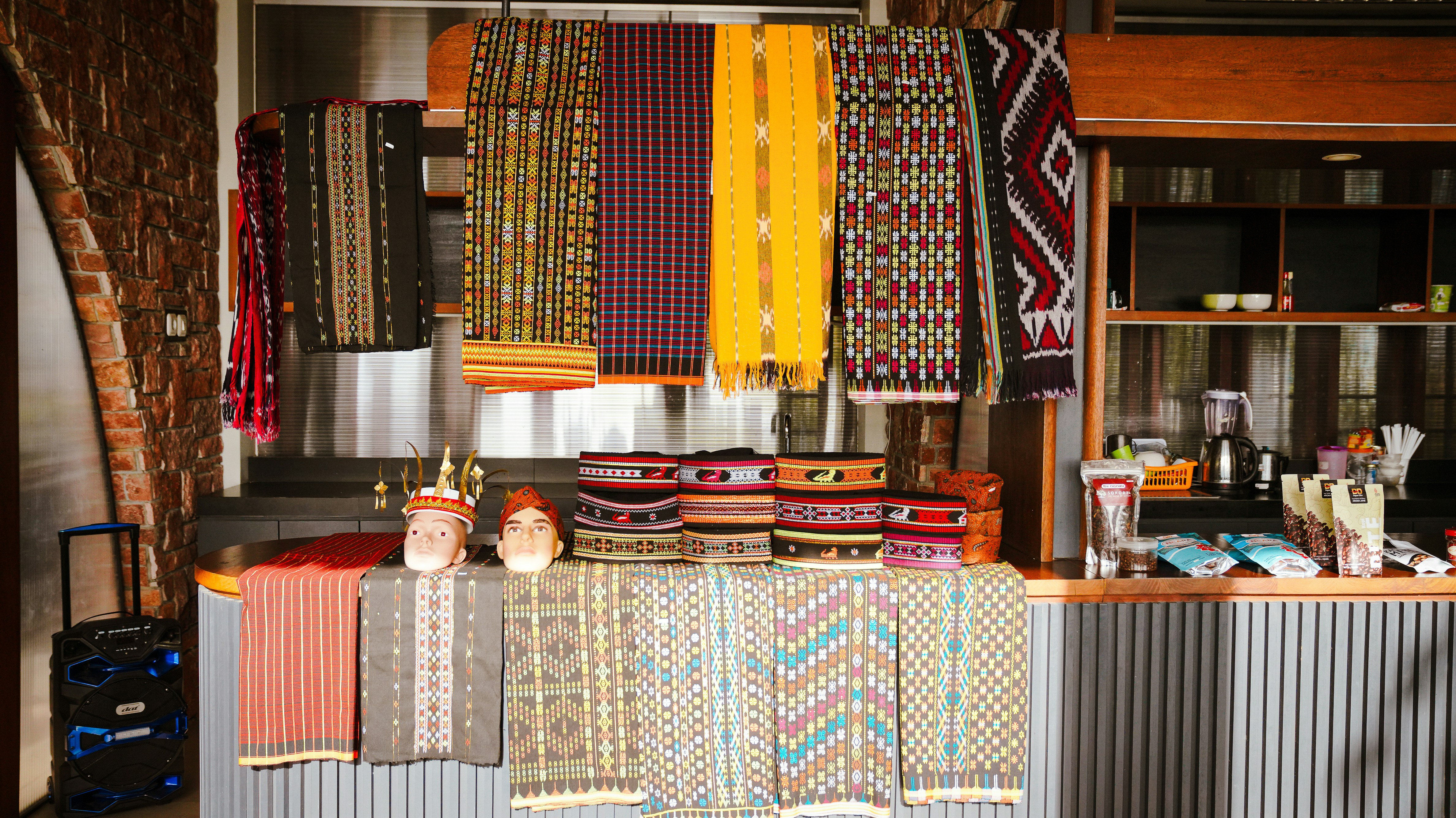 Colorful traditional woven textiles displayed in a local shop at Puncak Waringin, Labuan Bajo, highlighting Indonesian craftsmanship and cultural heritage.