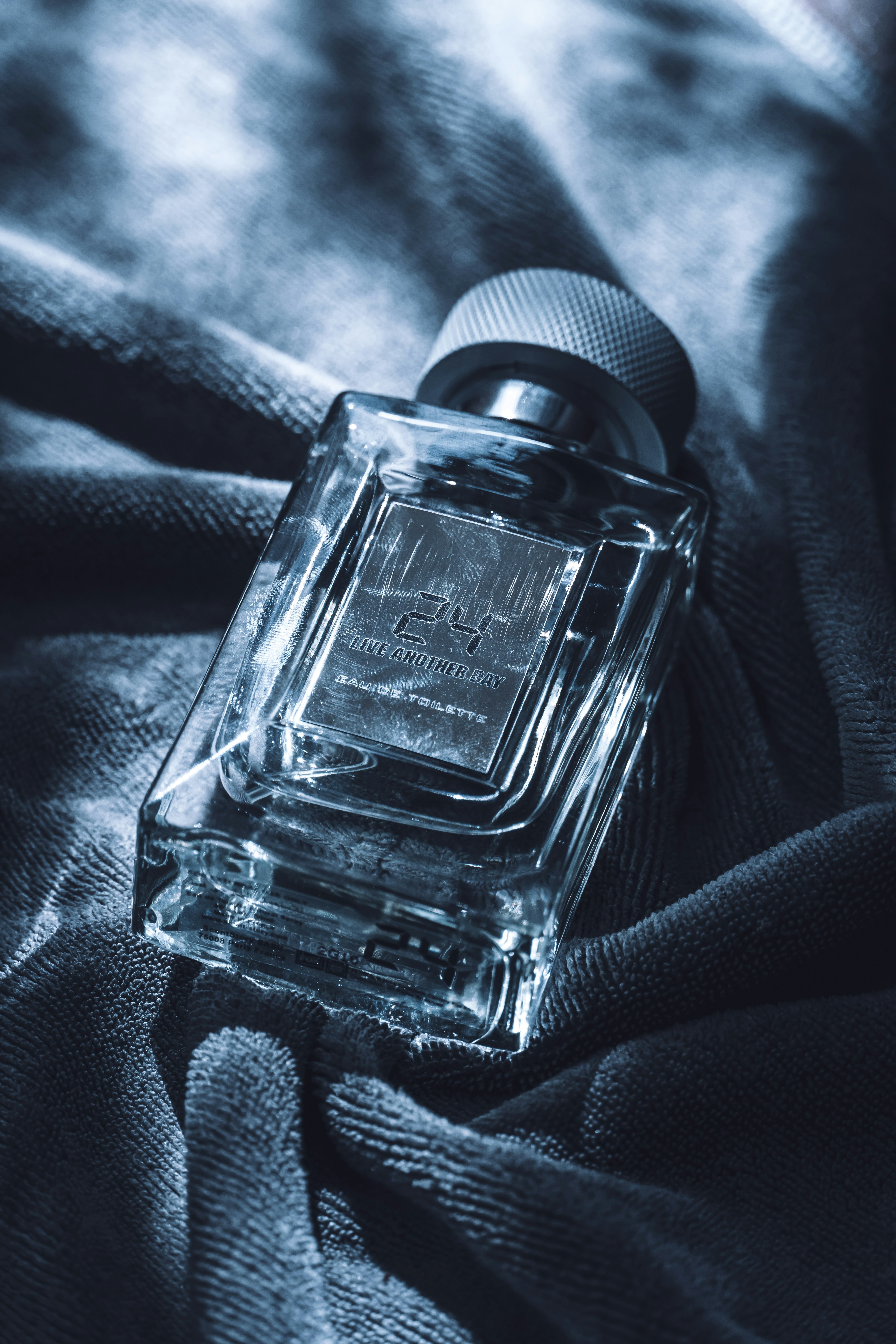 Clear glass perfume bottle with silver cap on velvet photo – Free Dark ...