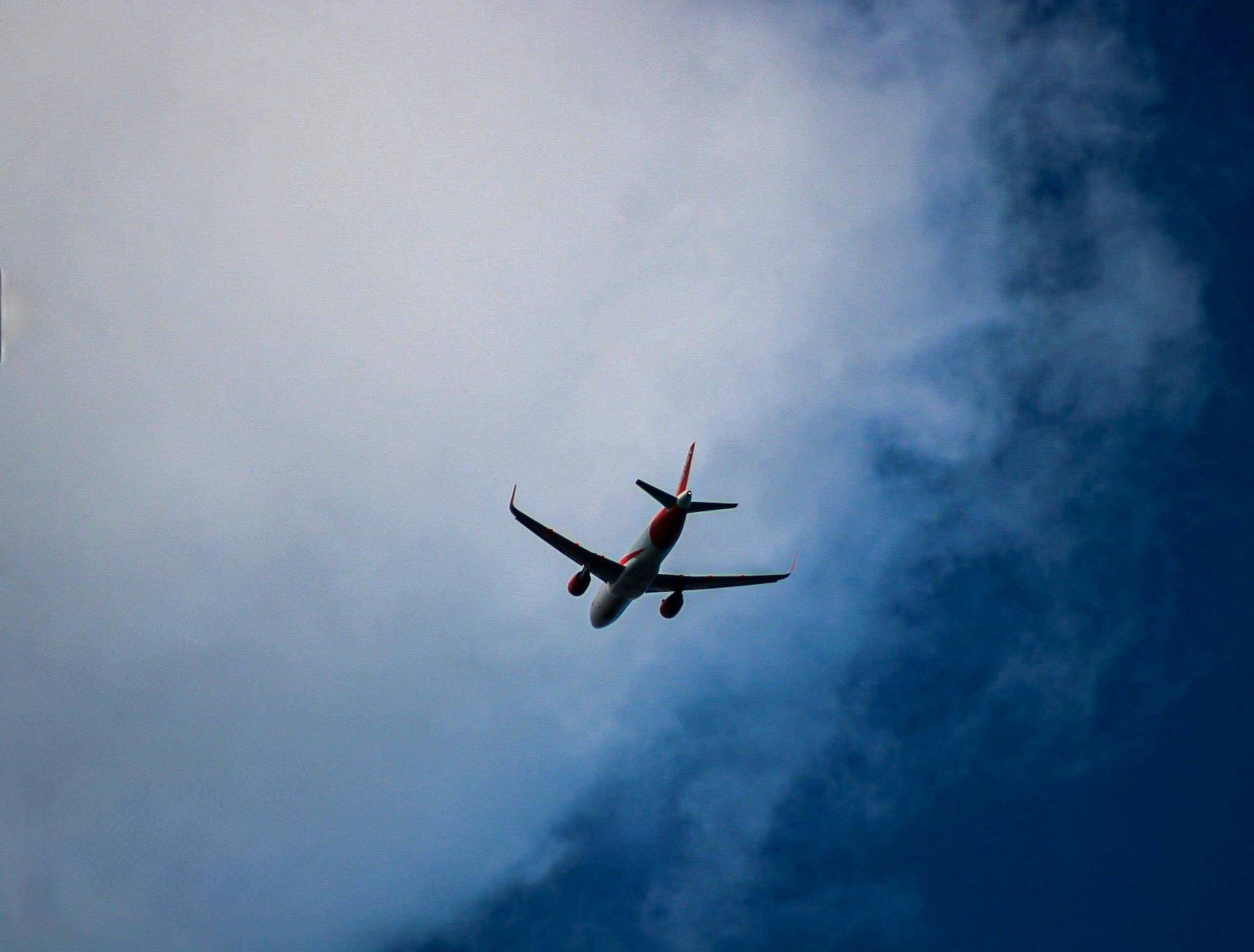 Plane flying through the blue sky
