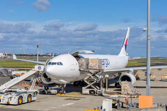 Cargo plane being loaded at an airport tarmac