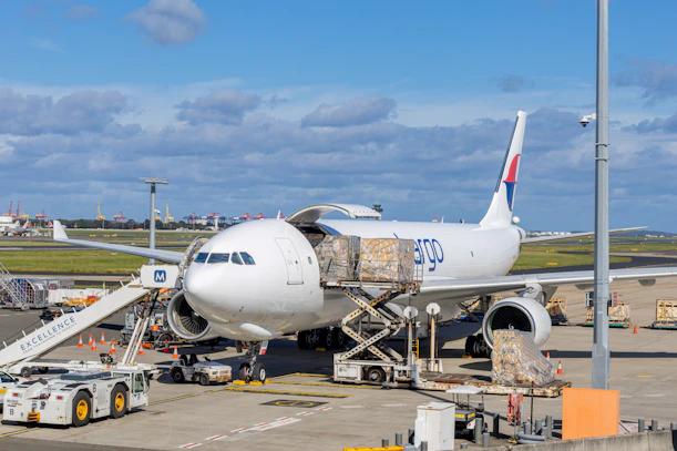 Cargo plane being loaded at an airport tarmac