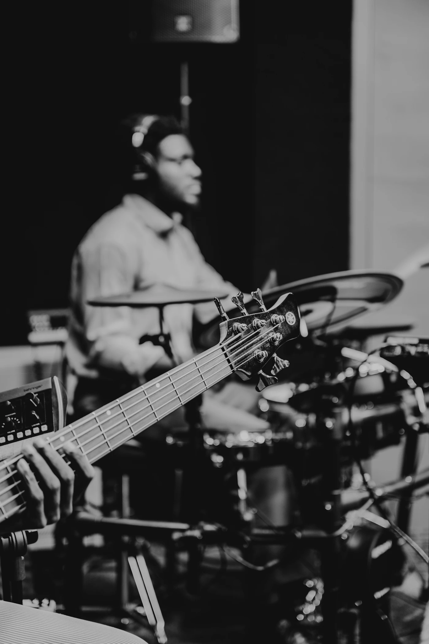 Two musicians rehearsing with drums and bass while their band reorganizes digital access