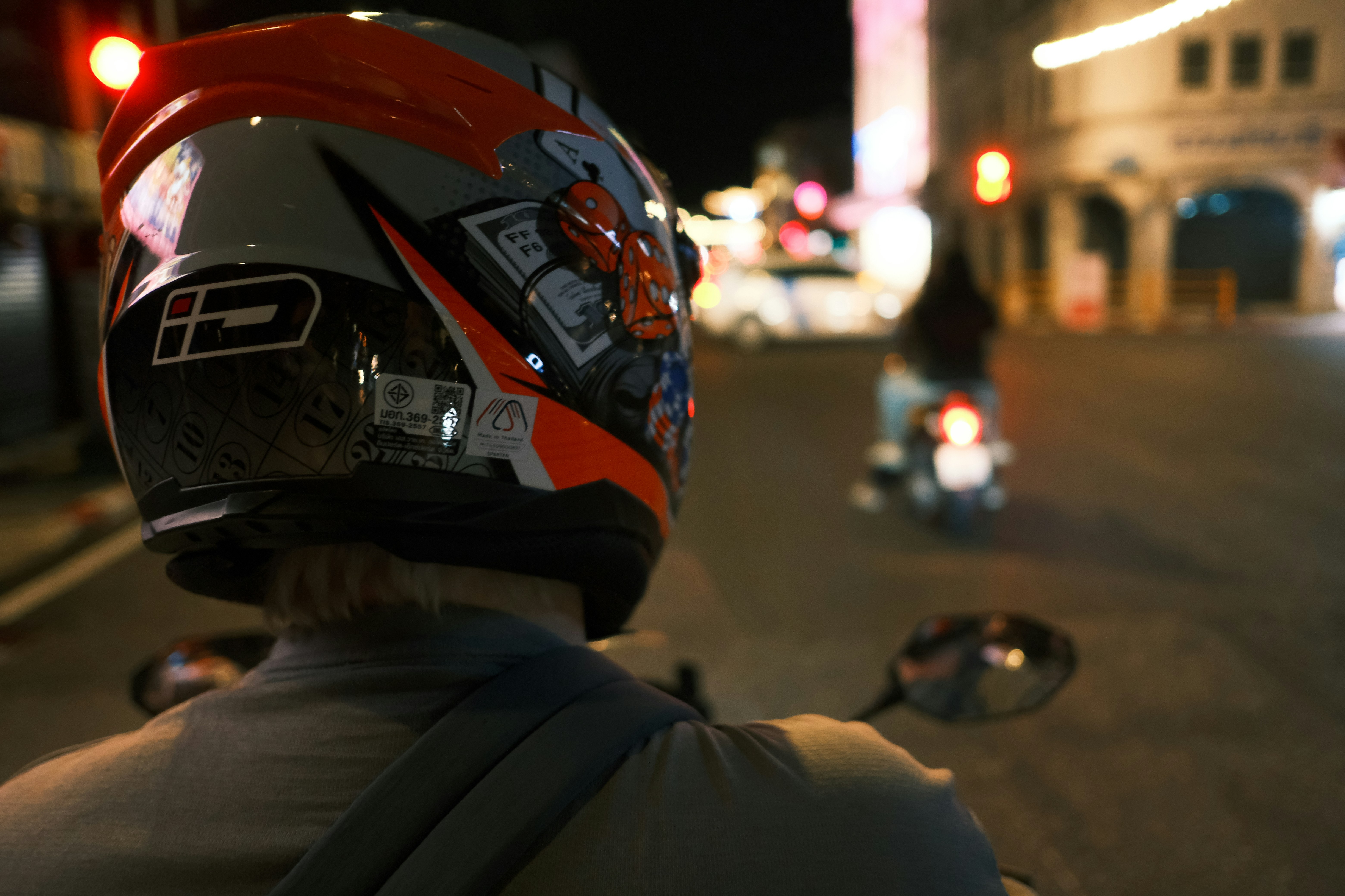 Scooter helmet hanging from a motorbike handlebar in Thailand