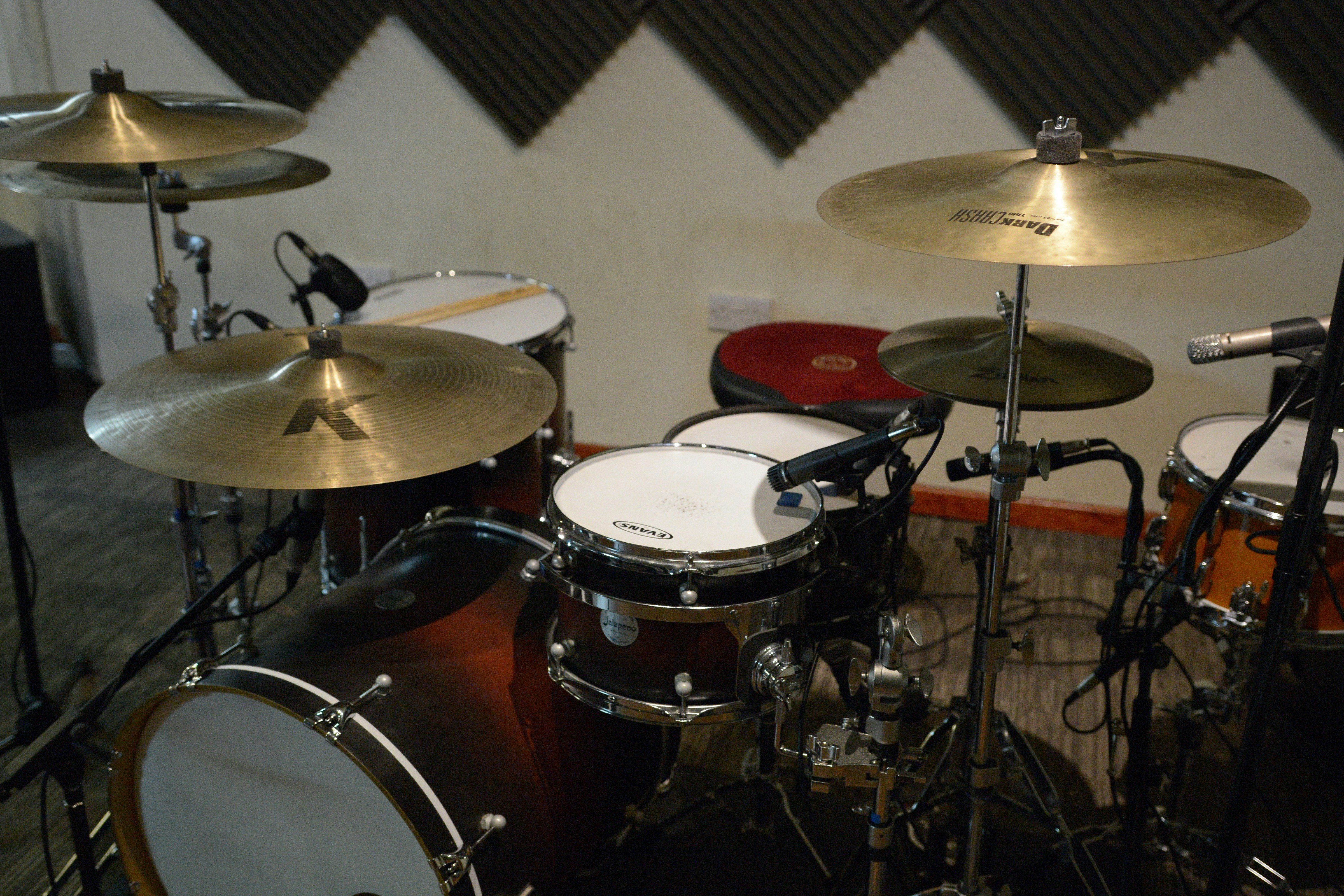 Drum kit with cymbals and microphones in studio