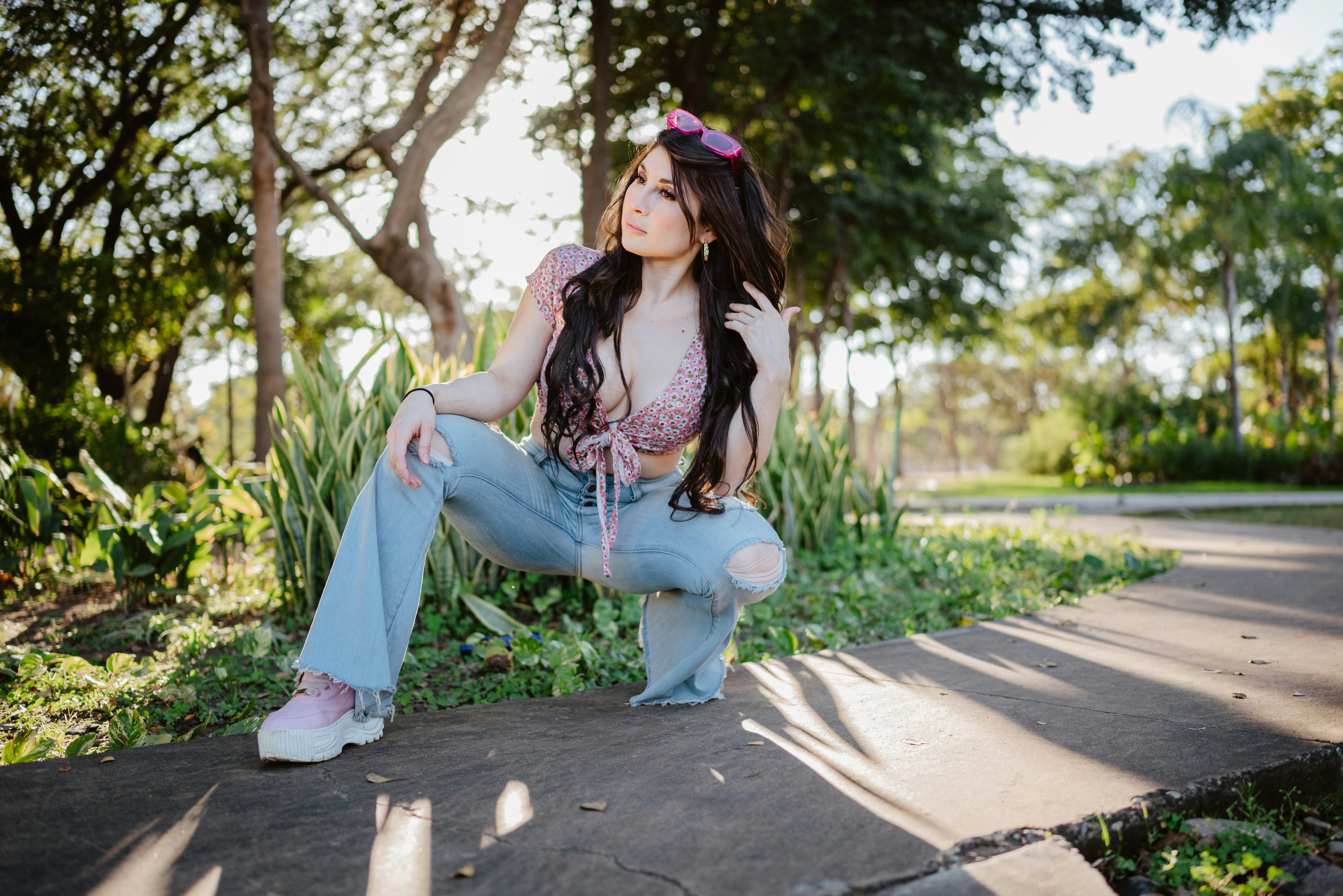 Young woman posing outdoors in sunlight