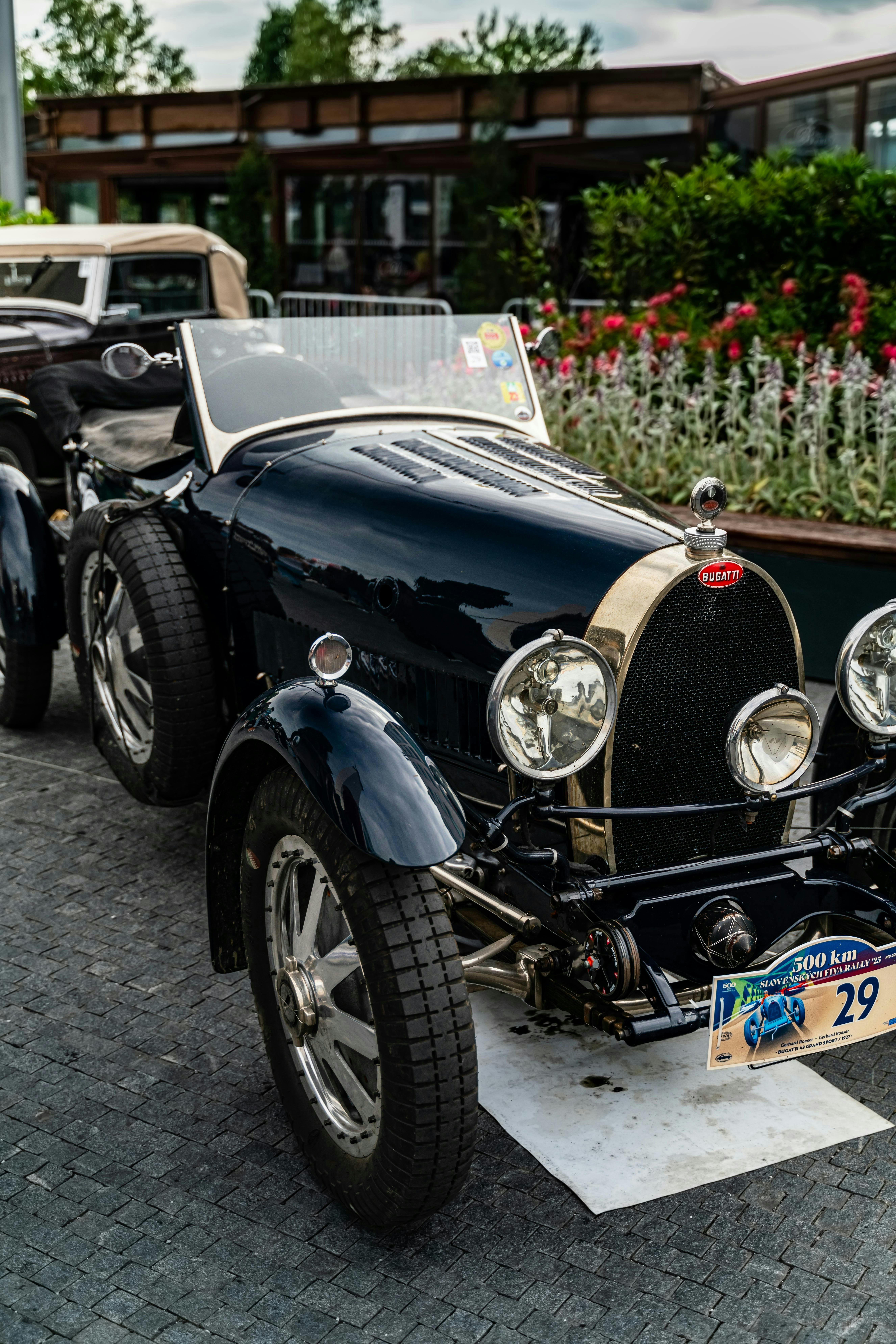 A vintage black bugatti car parked outdoors