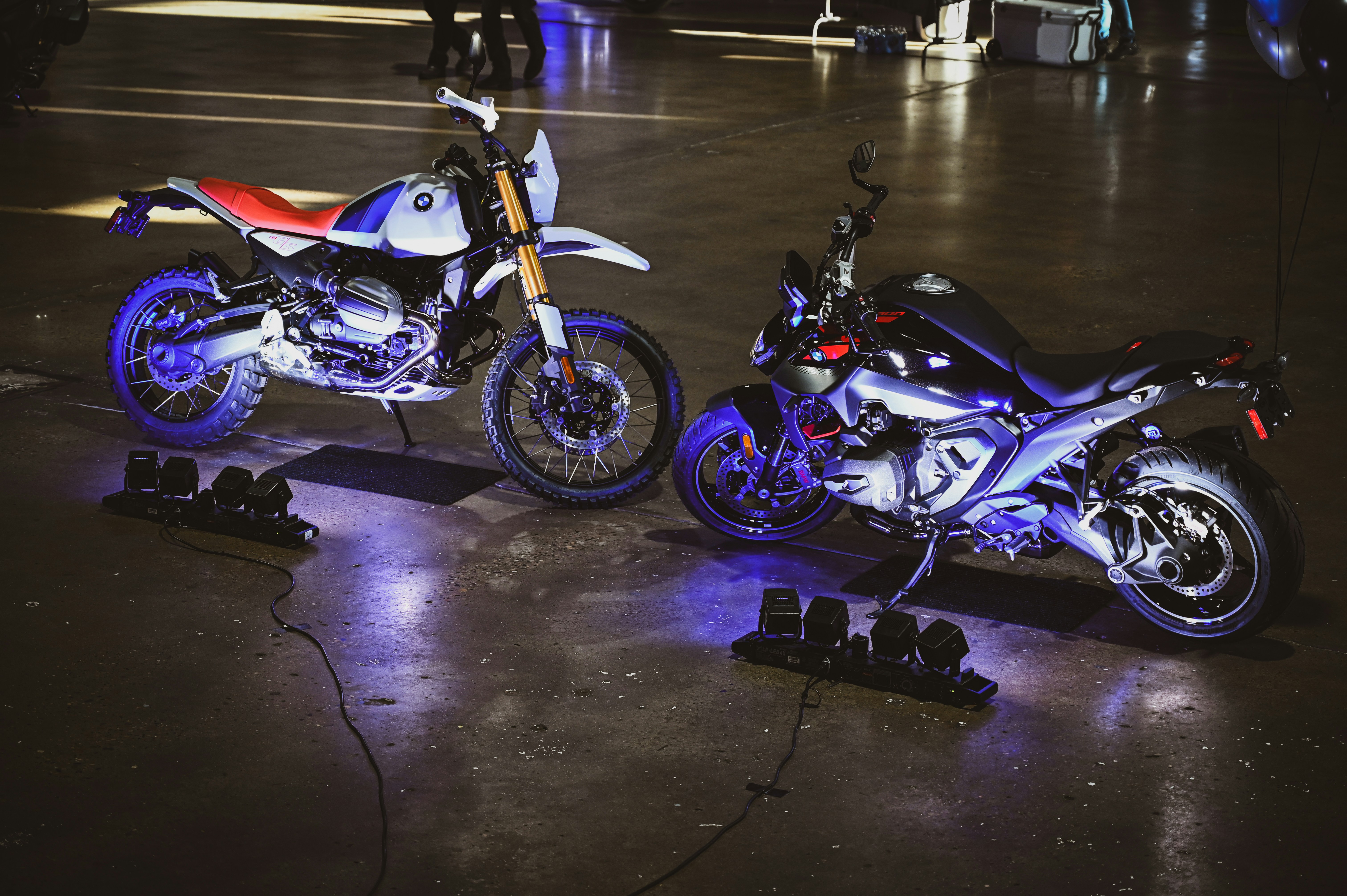 Two motorcycles illuminated with blue lights