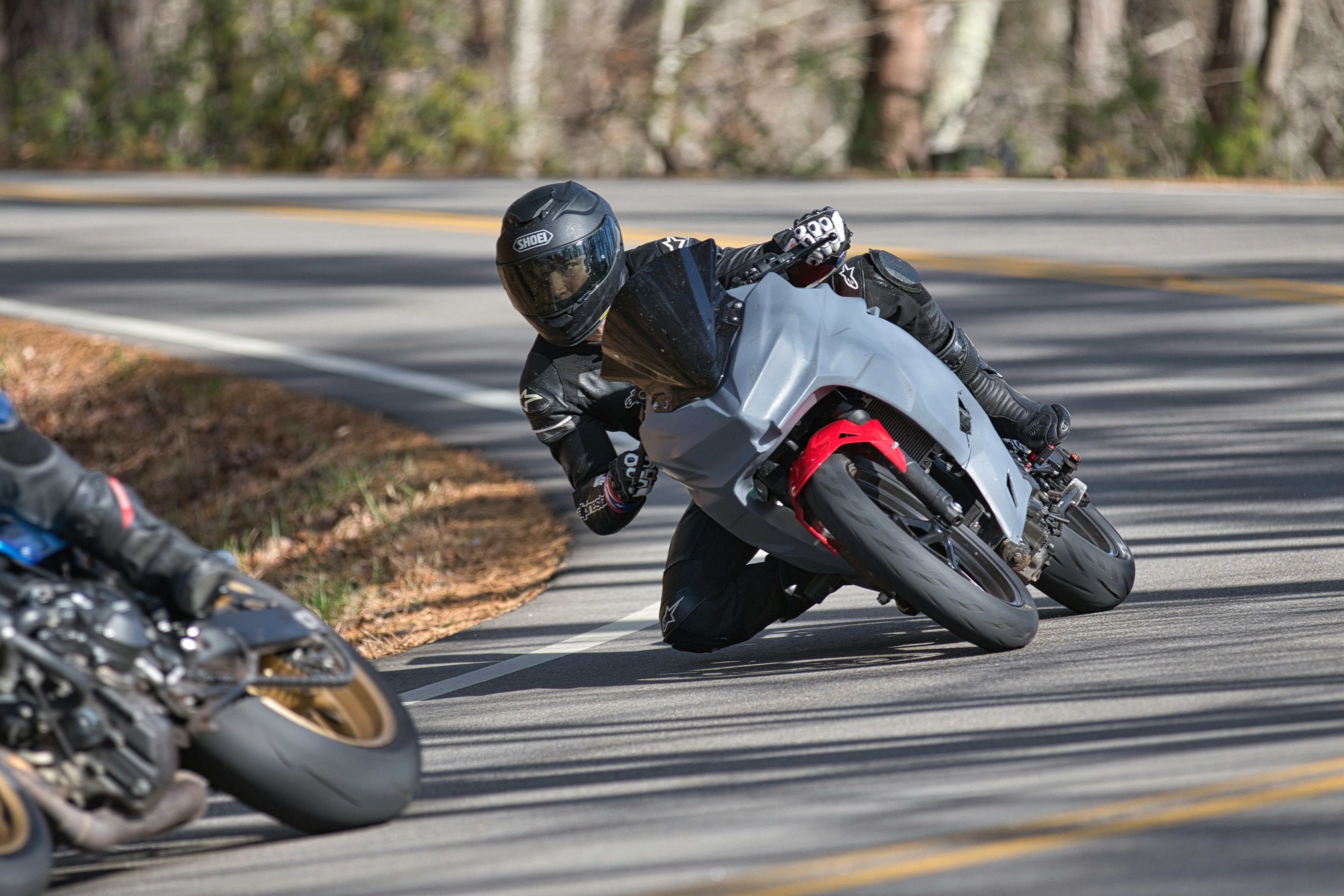 Motorcyclist leans into a sharp curve on a road