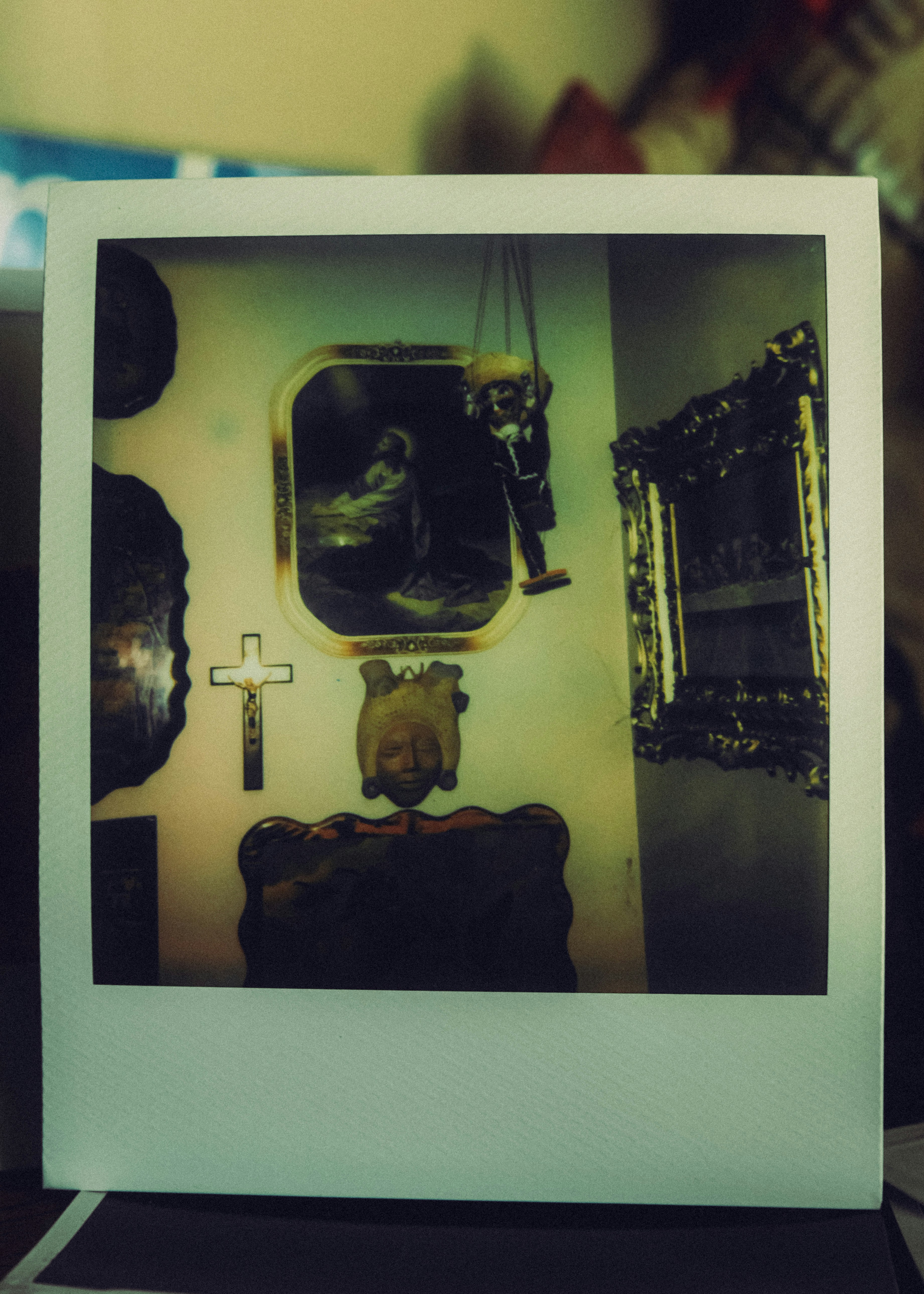 Religious artifacts and framed art on a wall