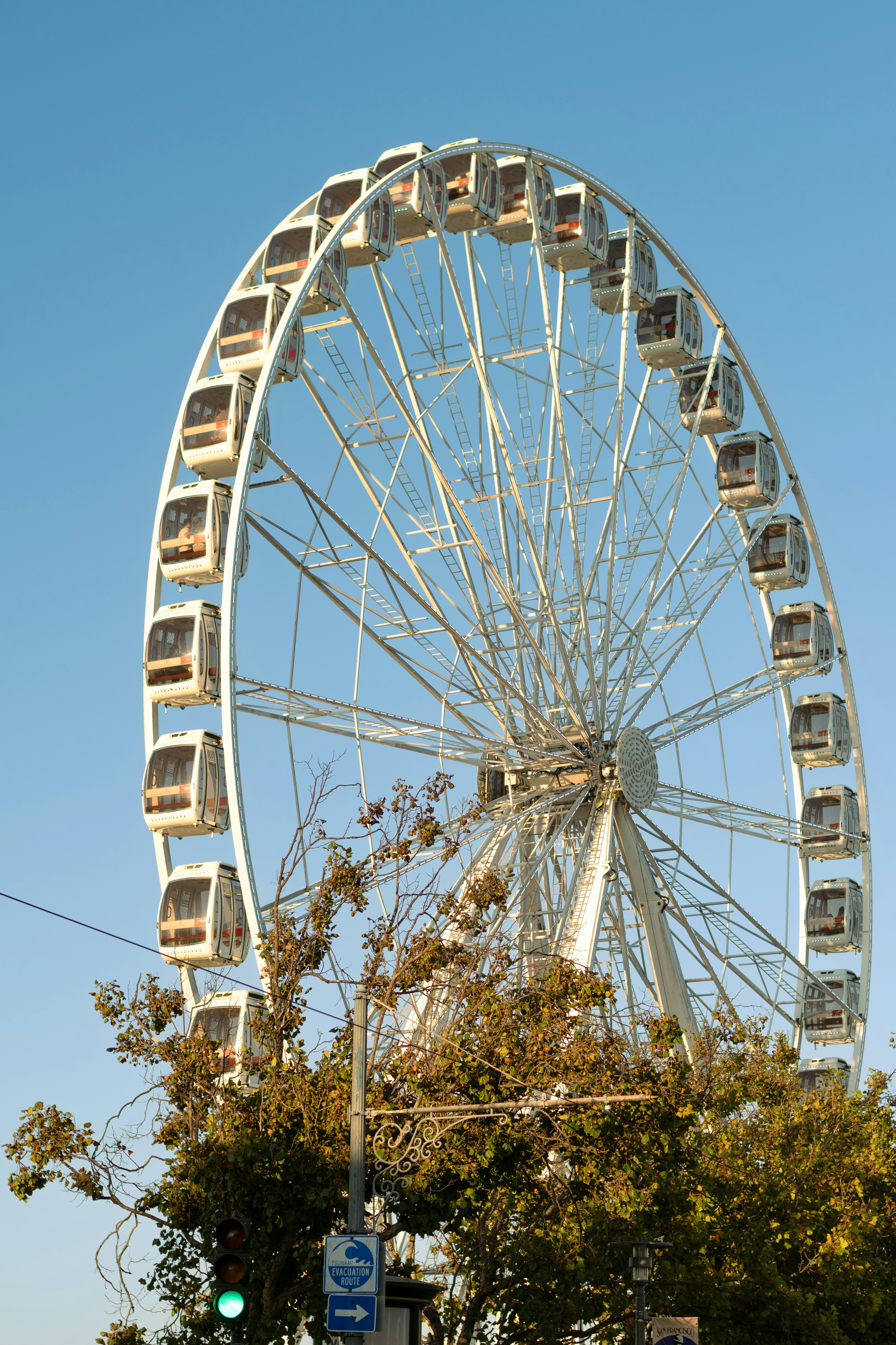 A large ferris wheel against a clear blue sky.