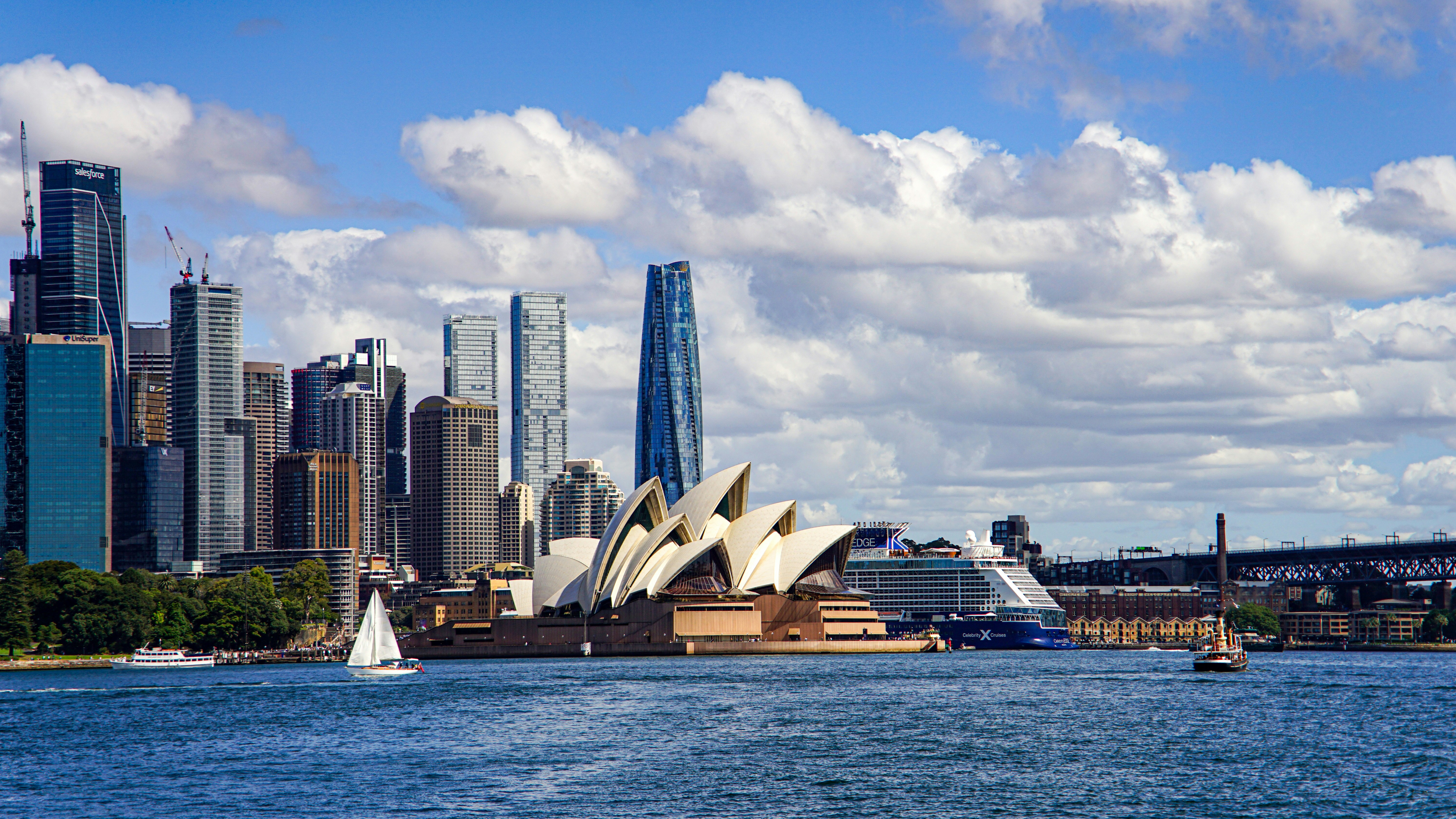 Sydney opera house and cityscape with sailboats on water