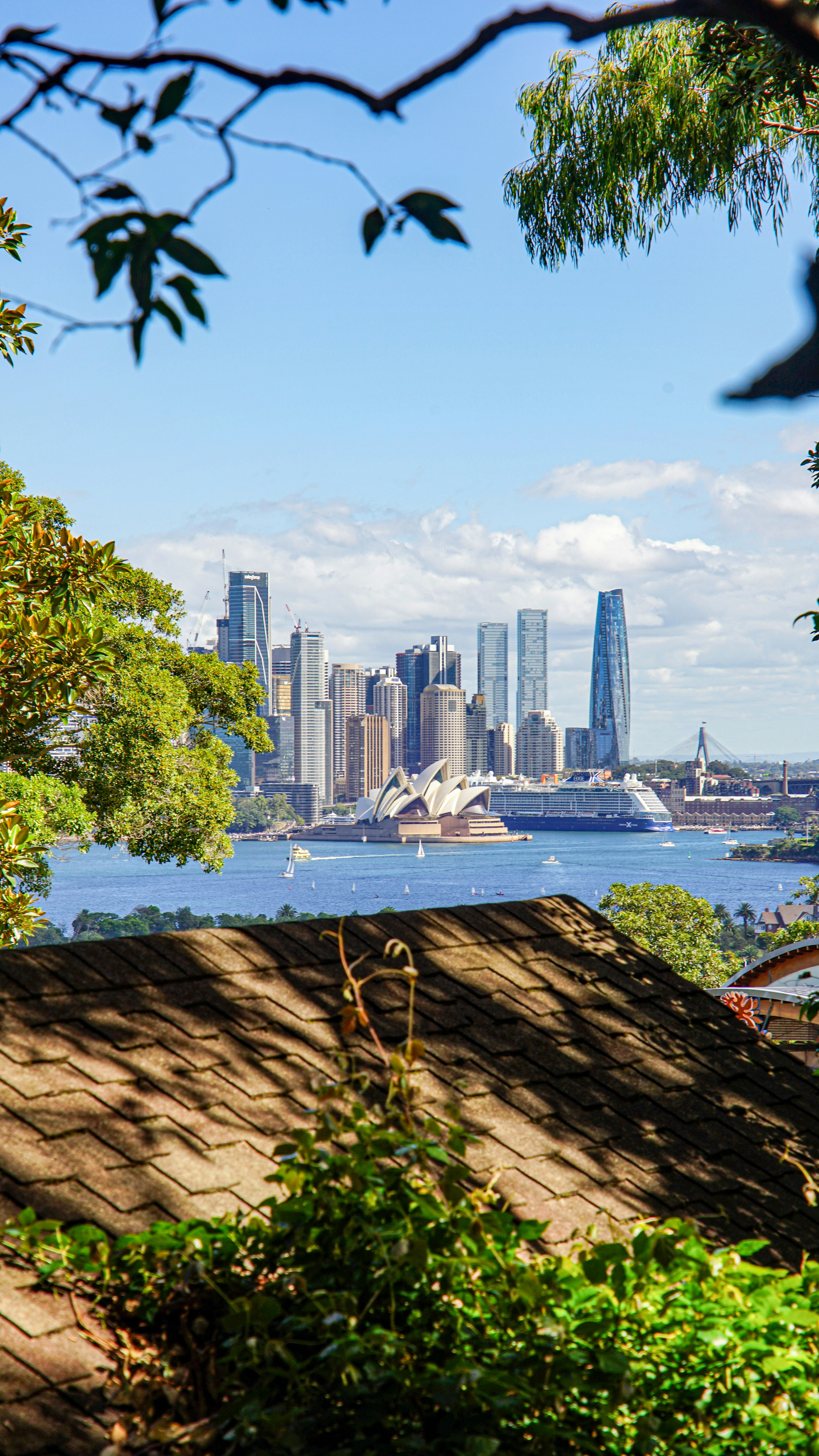 Sydney skyline with opera house and harbor.