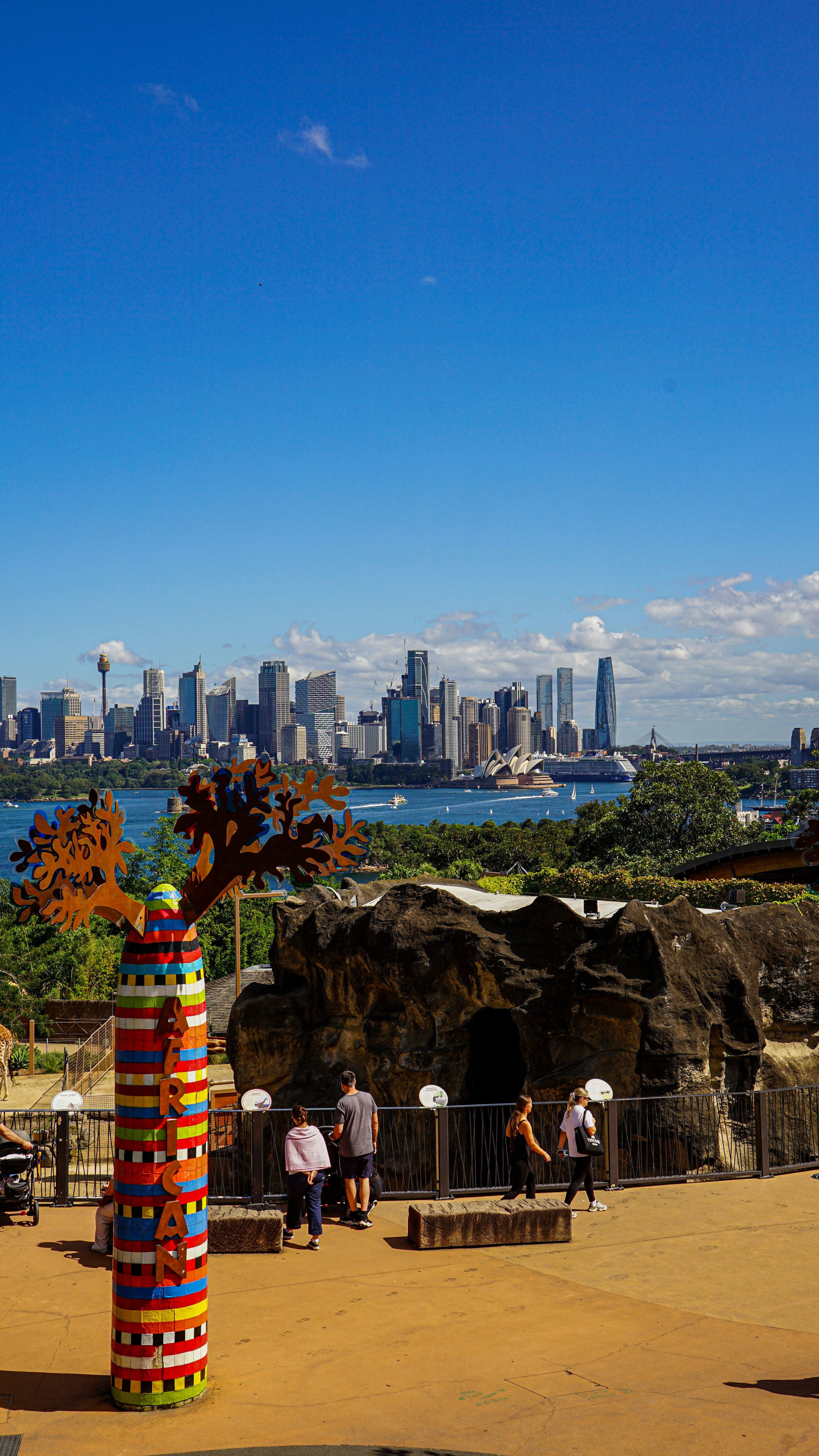 City skyline across a bay with people in foreground.
