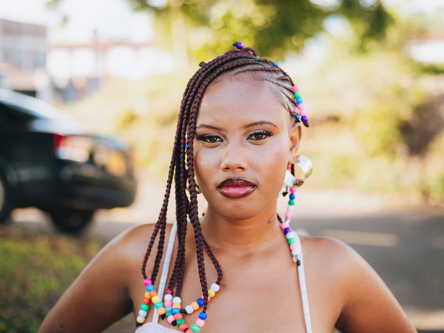 Woman wearing Fulani braids finished with coloured beads