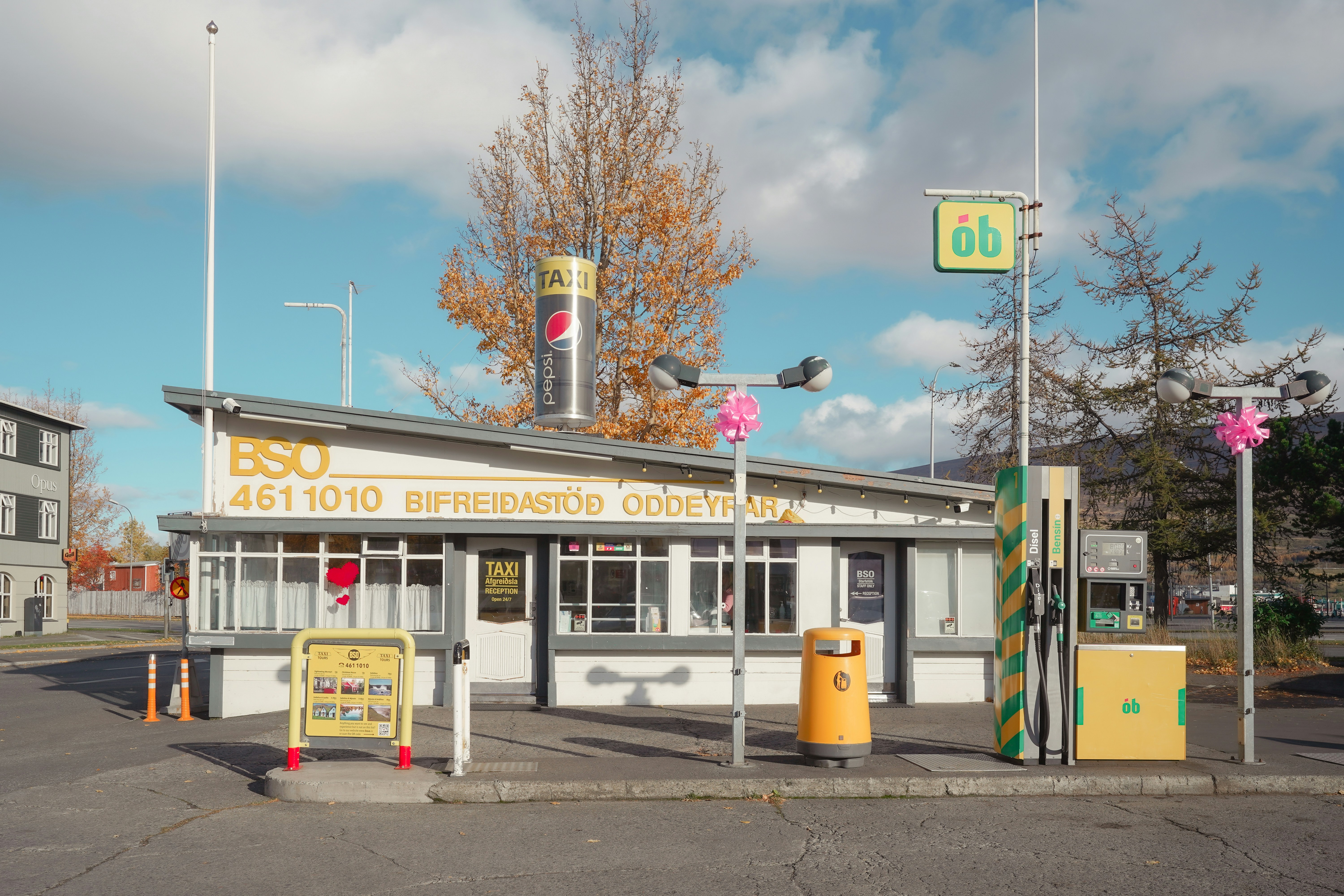 Retro gas station with yellow pumps and signage