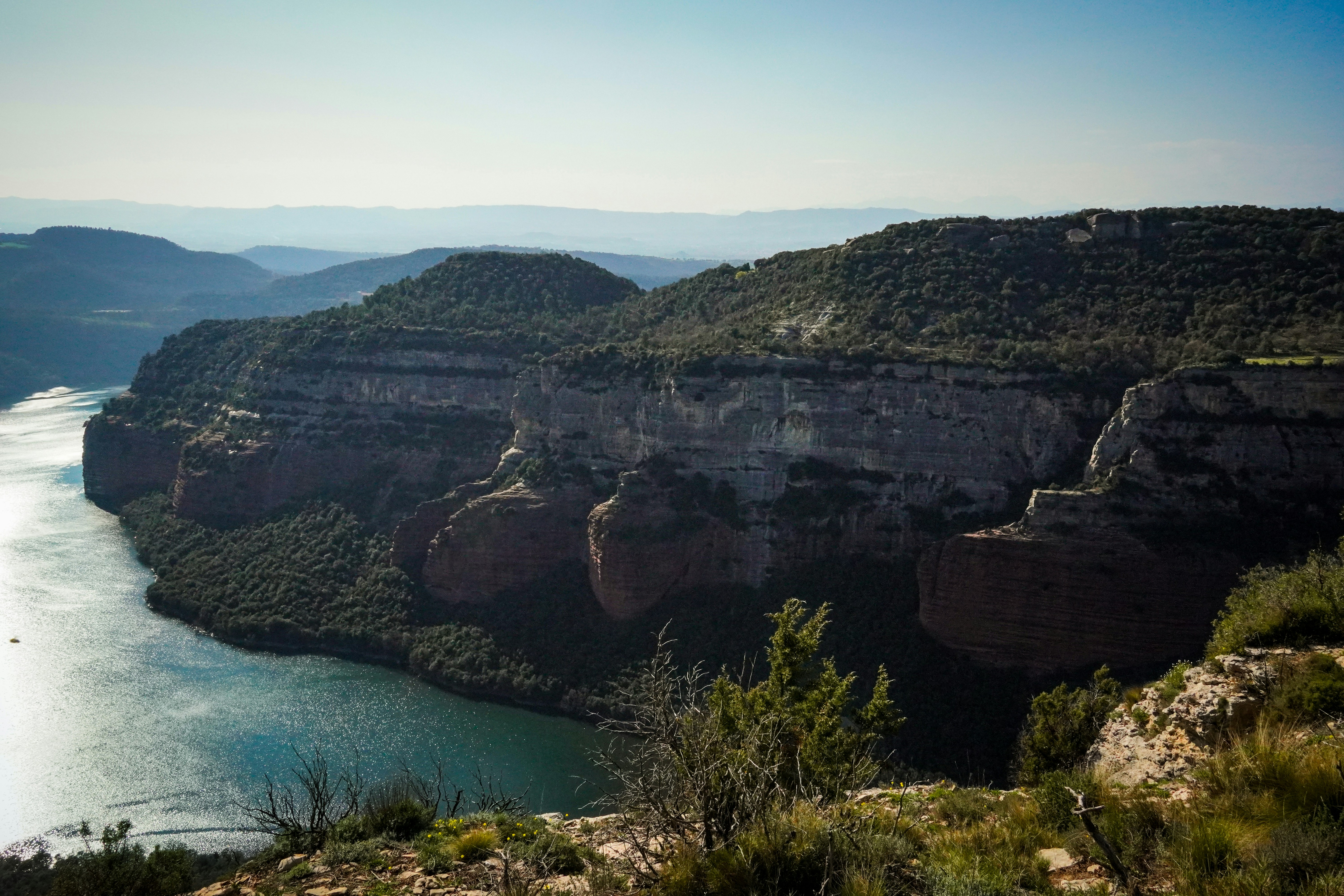 A scenic view of a river winding through forested cliffs.