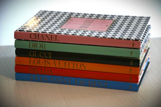 Stack of fashion books with designer names