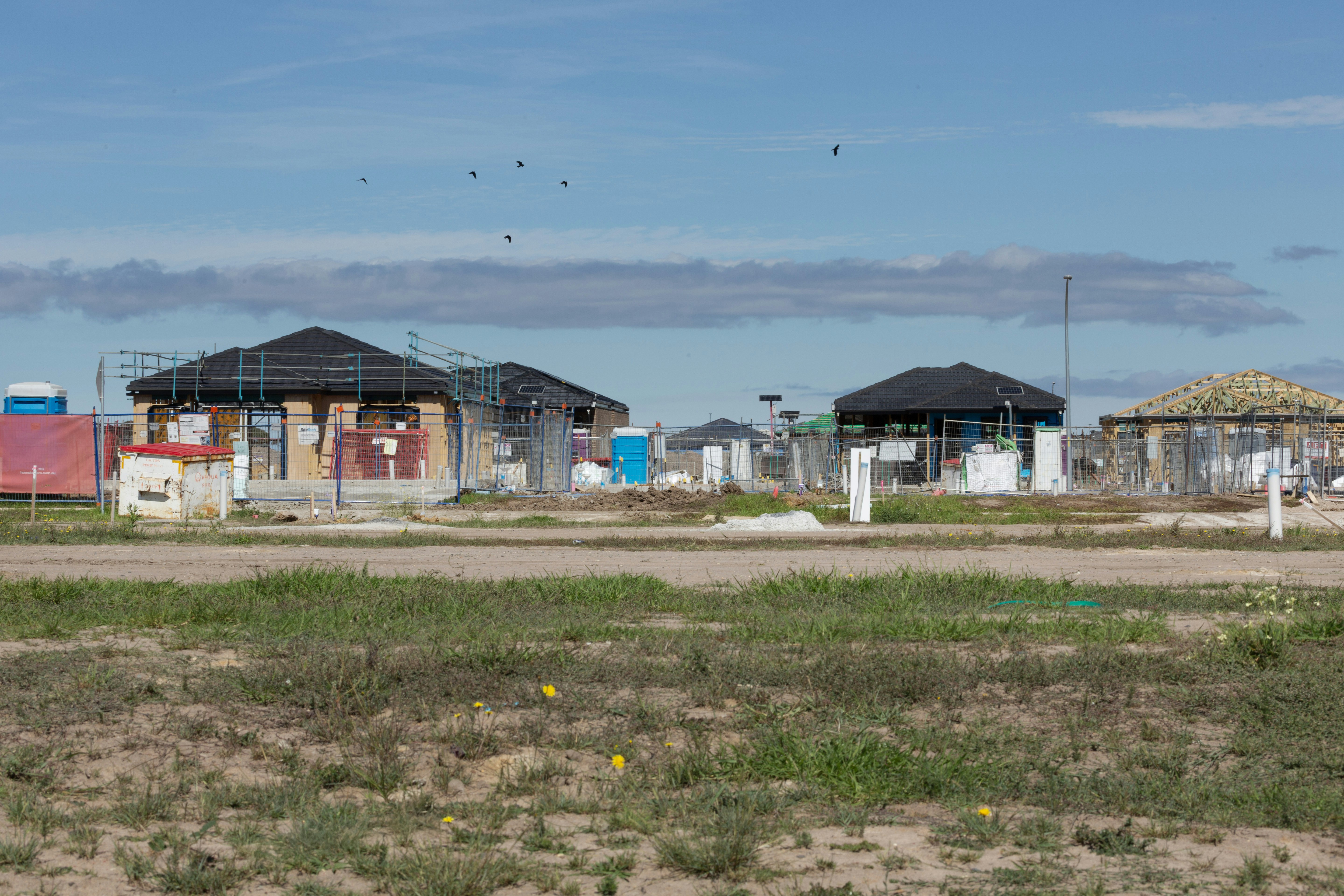 New houses under construction on a sunny day.