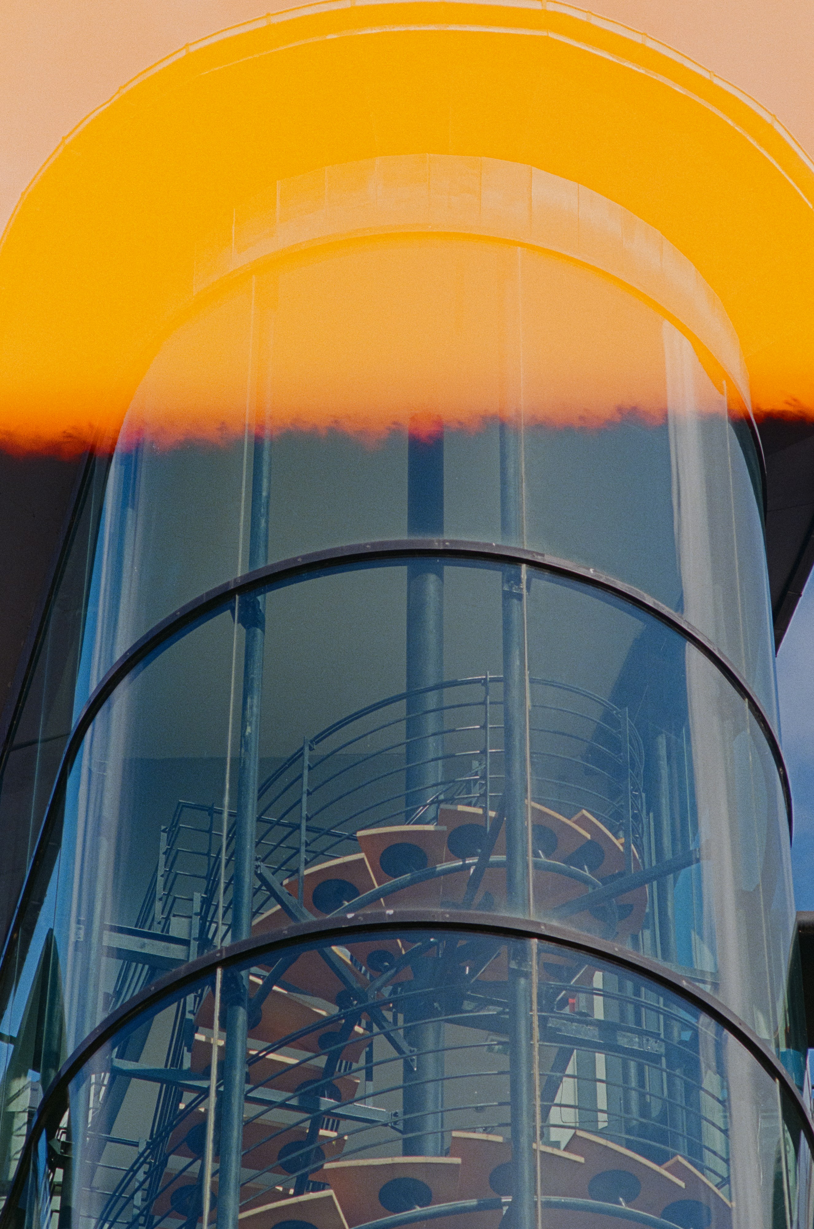 Modern glass spiral staircase inside building