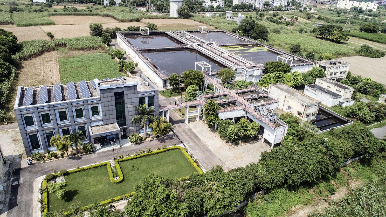Aerial view of a water treatment plant surrounded by fields