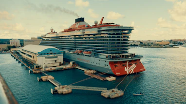 A large cruise ship docked at a pier.