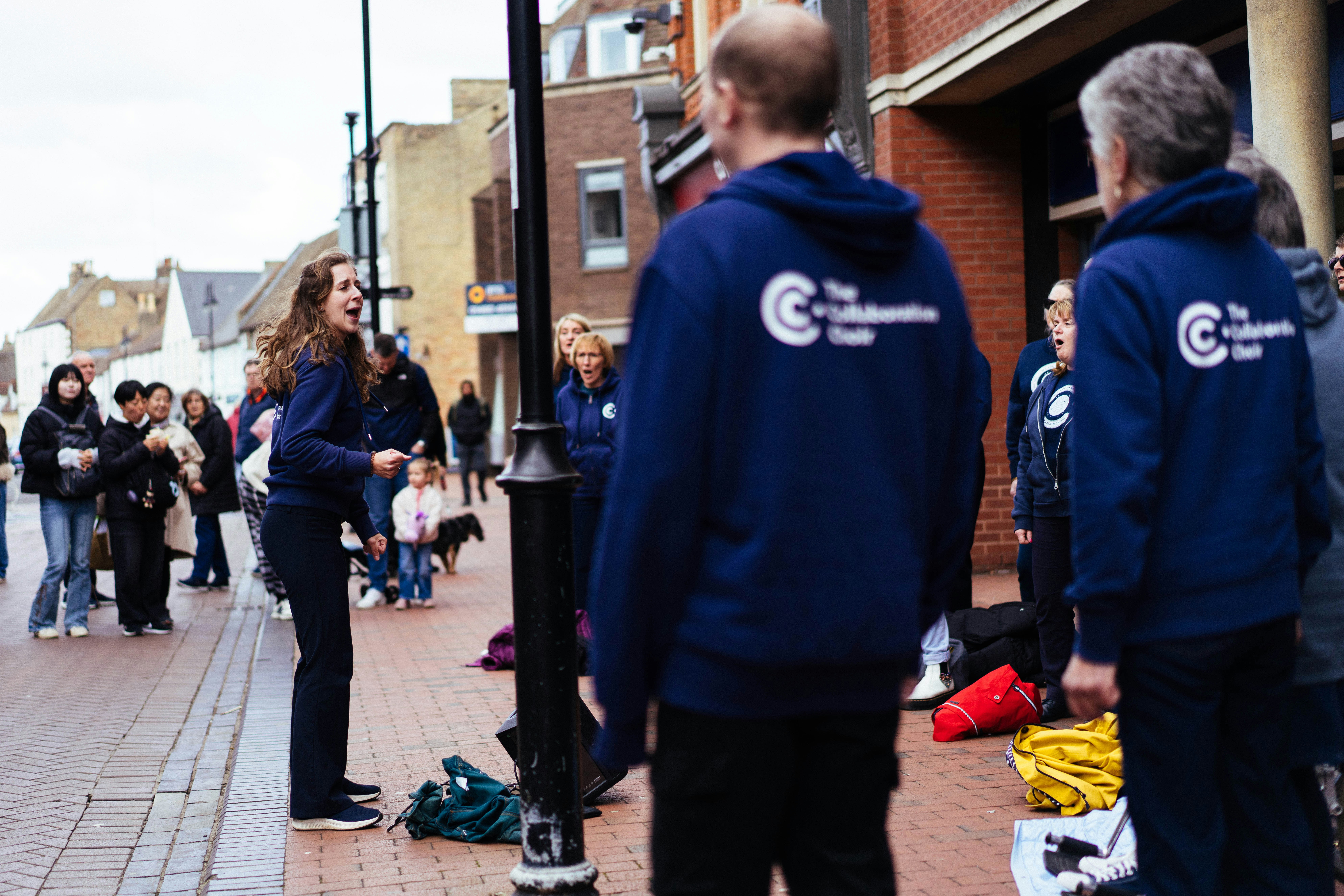 Group in blue hoodies on a street